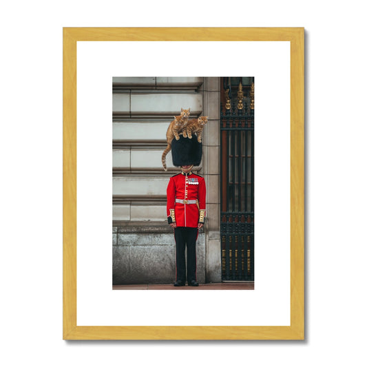 Royal Guard in traditional red and black uniform with bearskin hat standing at attention.