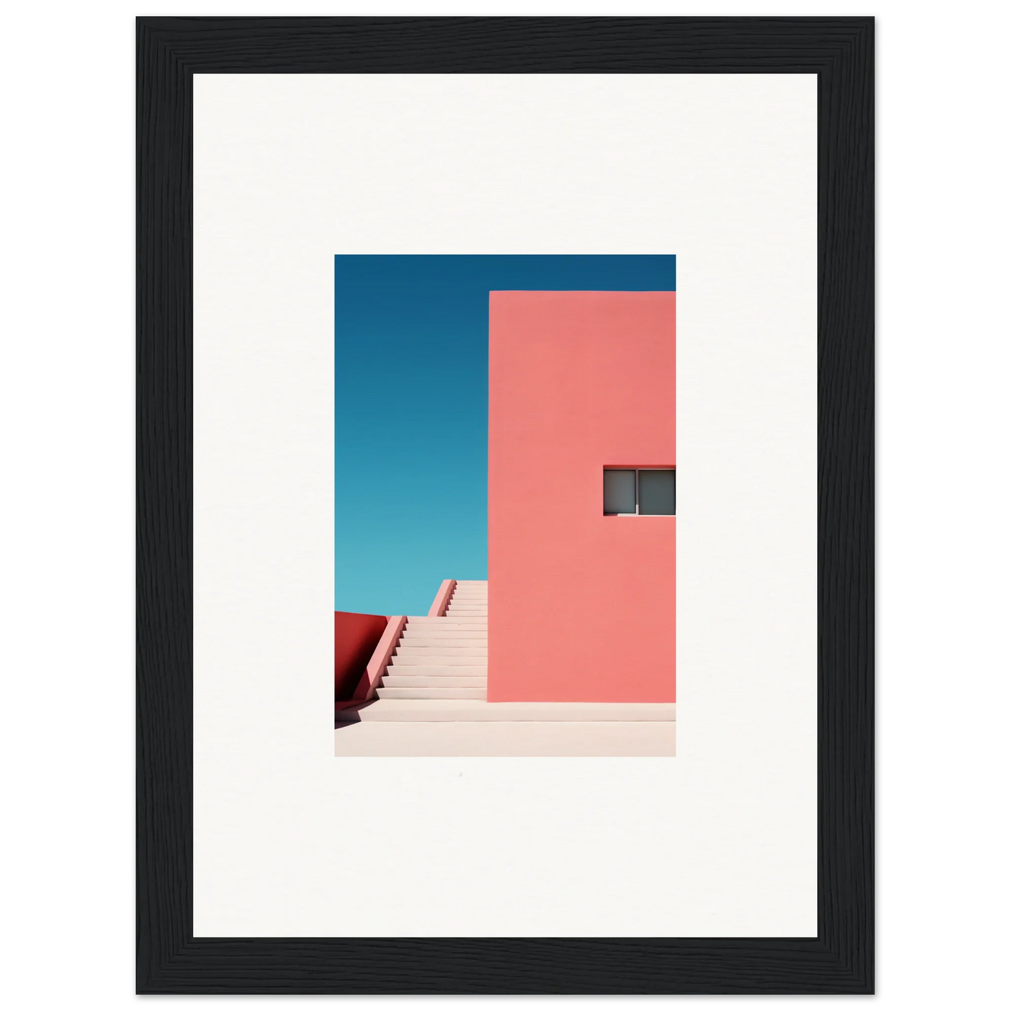 Framed wall art of a pink wall and staircase against a blue sky in Cerulean Dream Ickles