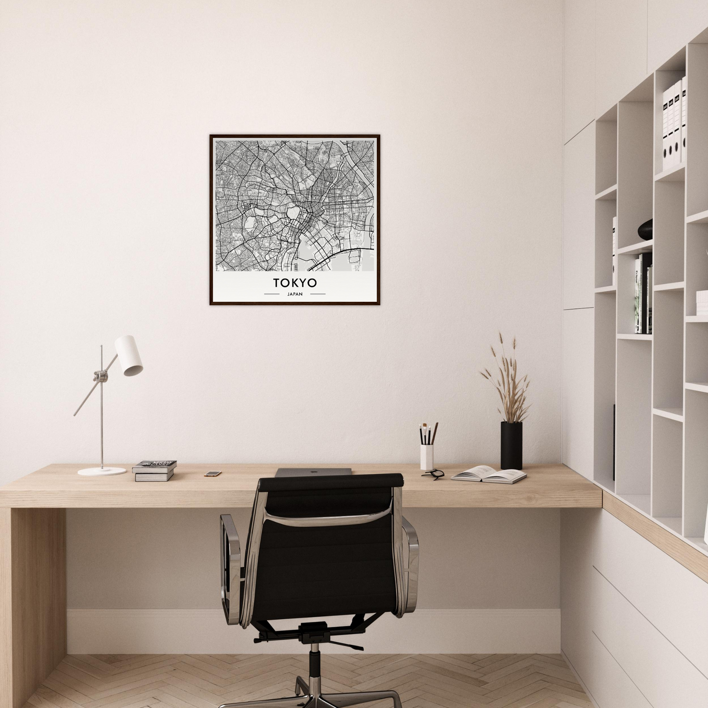 Minimalist wooden desk with a black office chair in a home workspace.