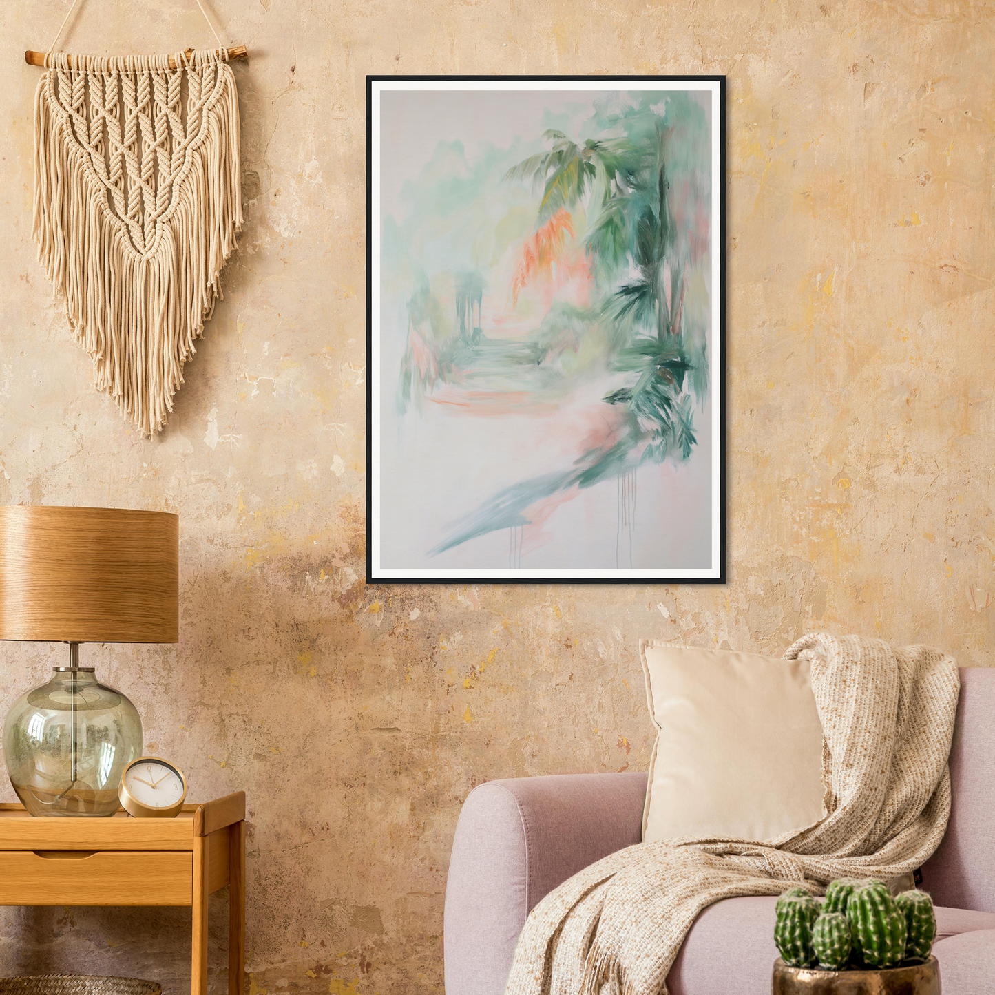 Framed wall art above a sofa, with lamp, table, and macrame enhancing the room decor.