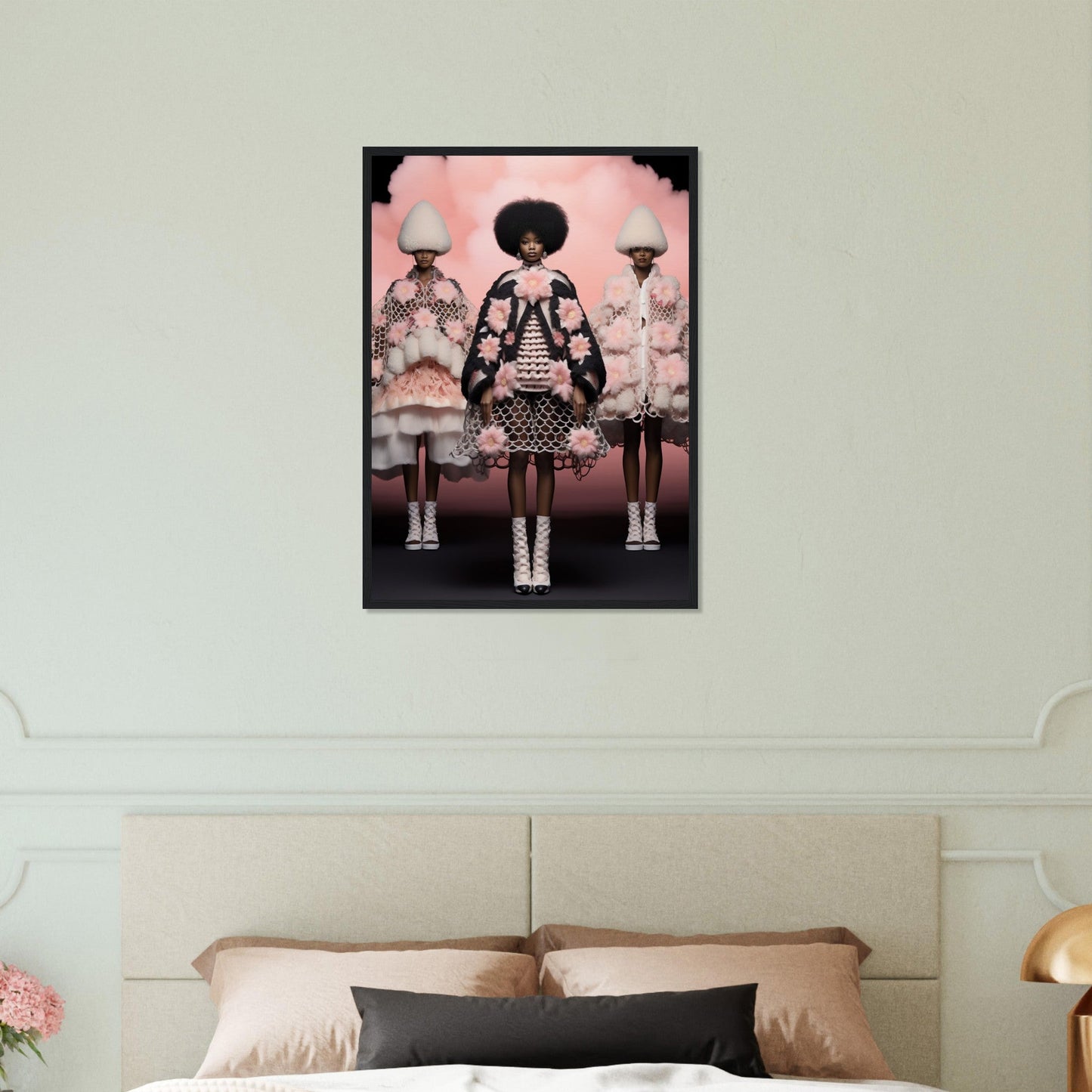Framed artwork depicting three stylized female figures in elaborate dresses against a pink background.
