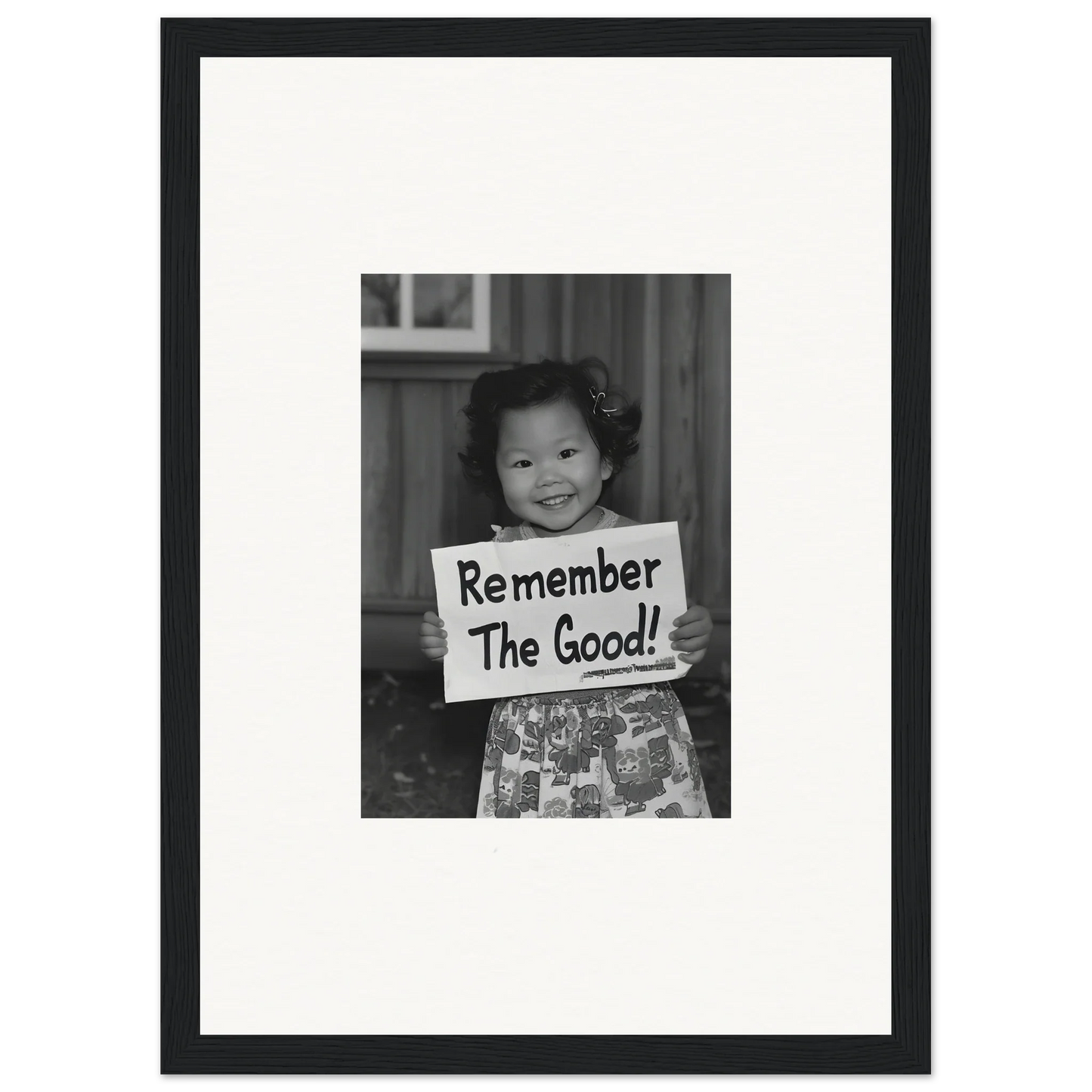 Young child with a sign saying Remember The Good in Essence Savor Whispers framed wall art