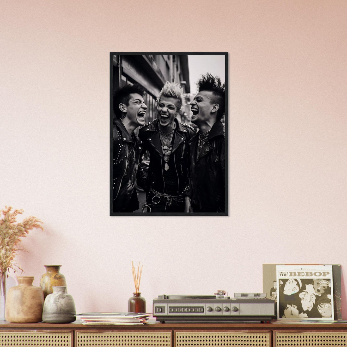 Black and white photograph of three punk rockers laughing together, framed and mounted on a wall.