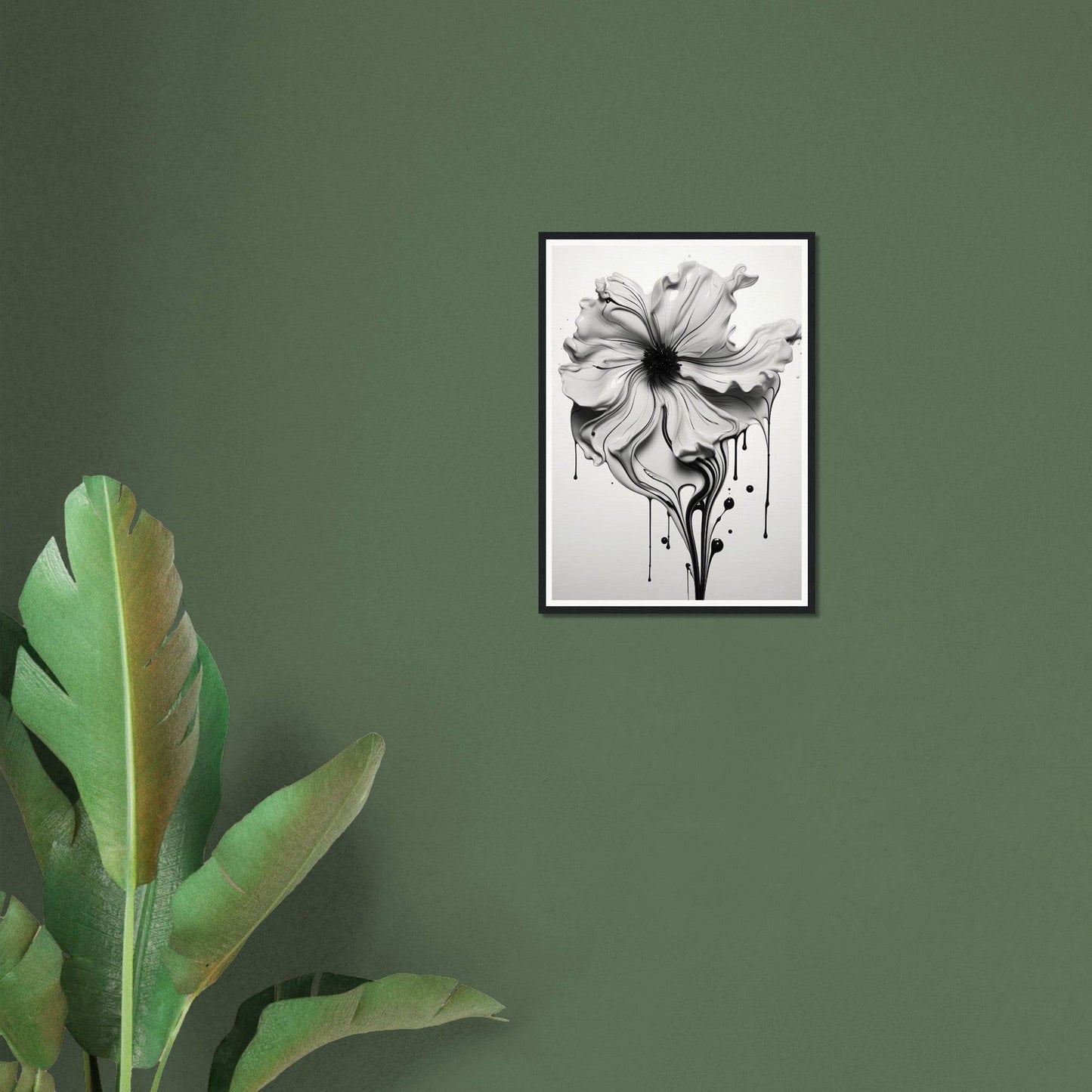 A black and white flower on a green wall