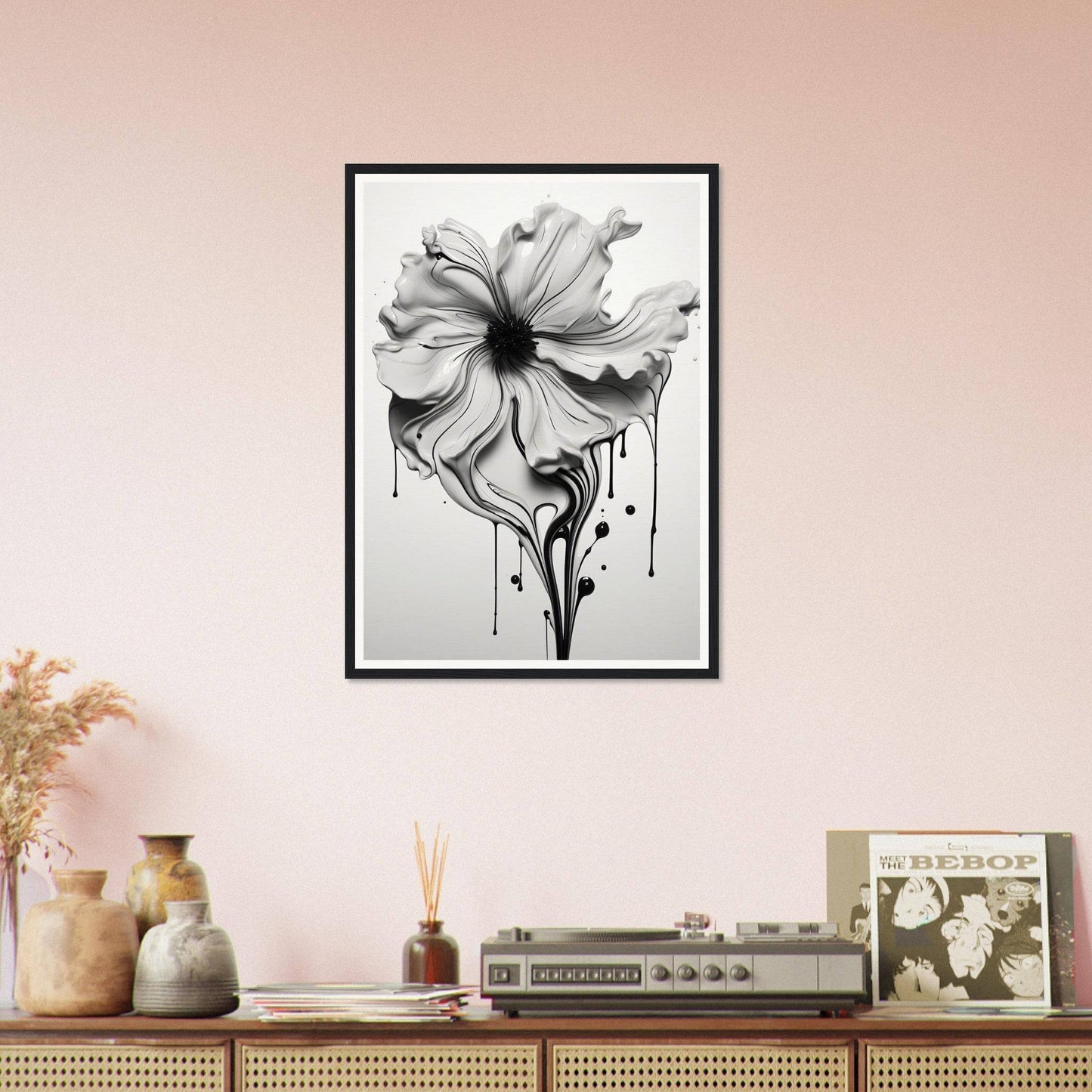 A black and white flower on a pink wall