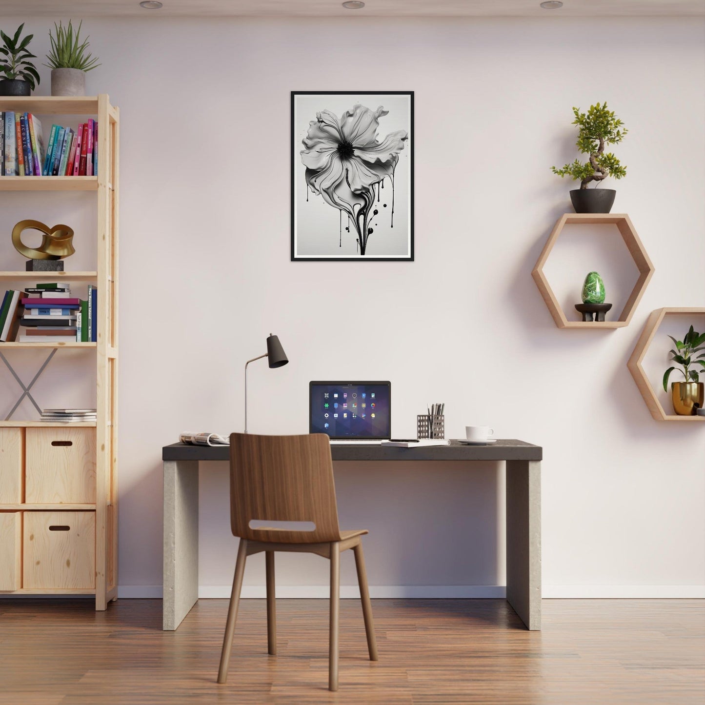 A black and white photo of a flower on a wall above a desk