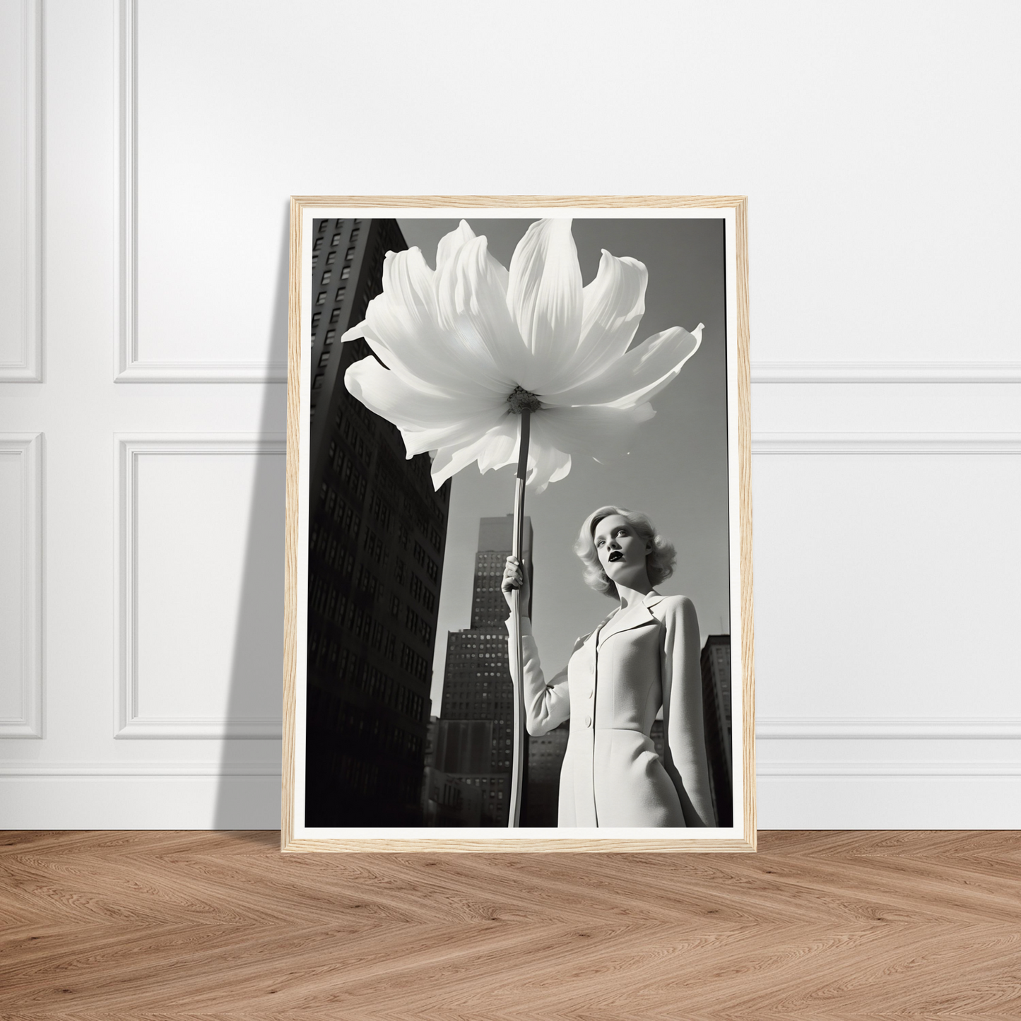 A black and white photo of a woman holding a large white flower