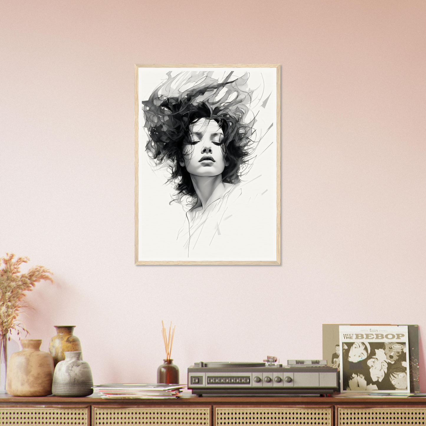A black and white drawing of a woman’s face on a pink wall