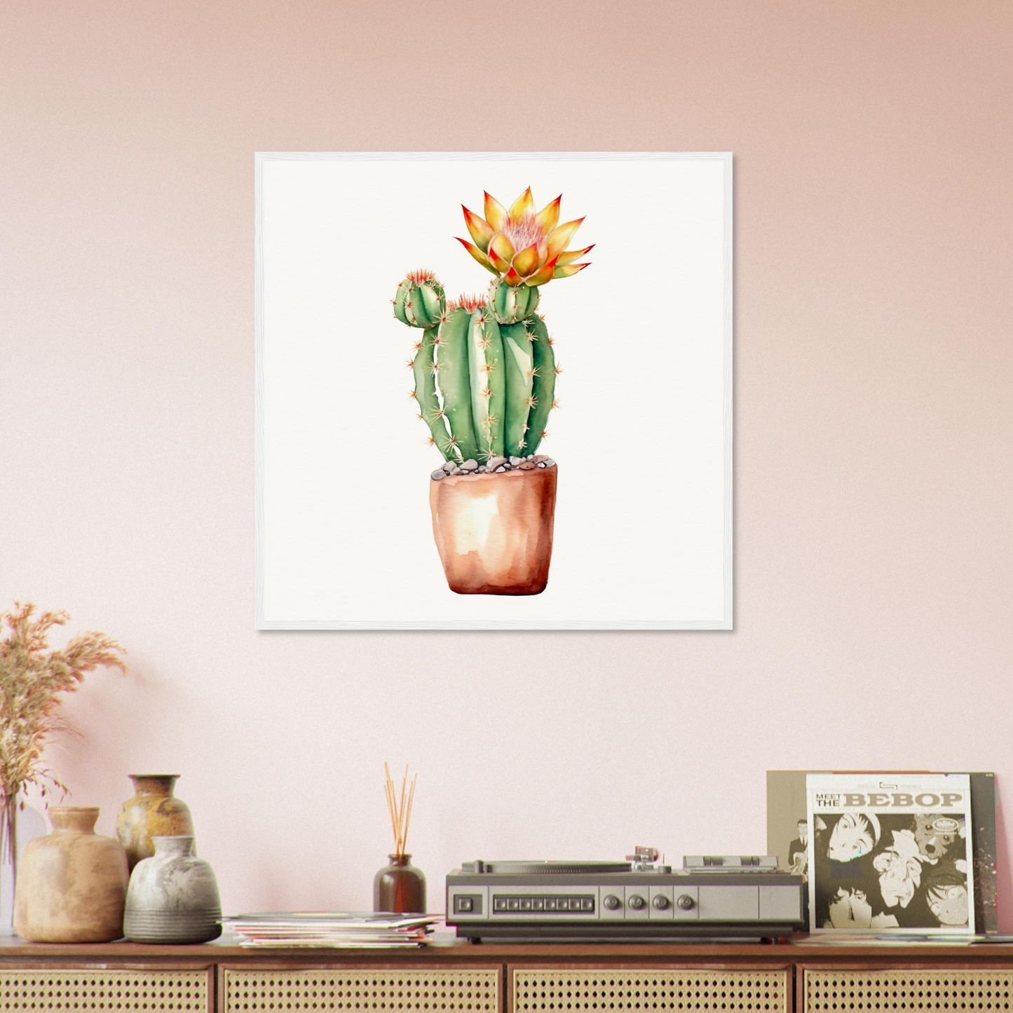 A cactus plant in a pot on a pink wall