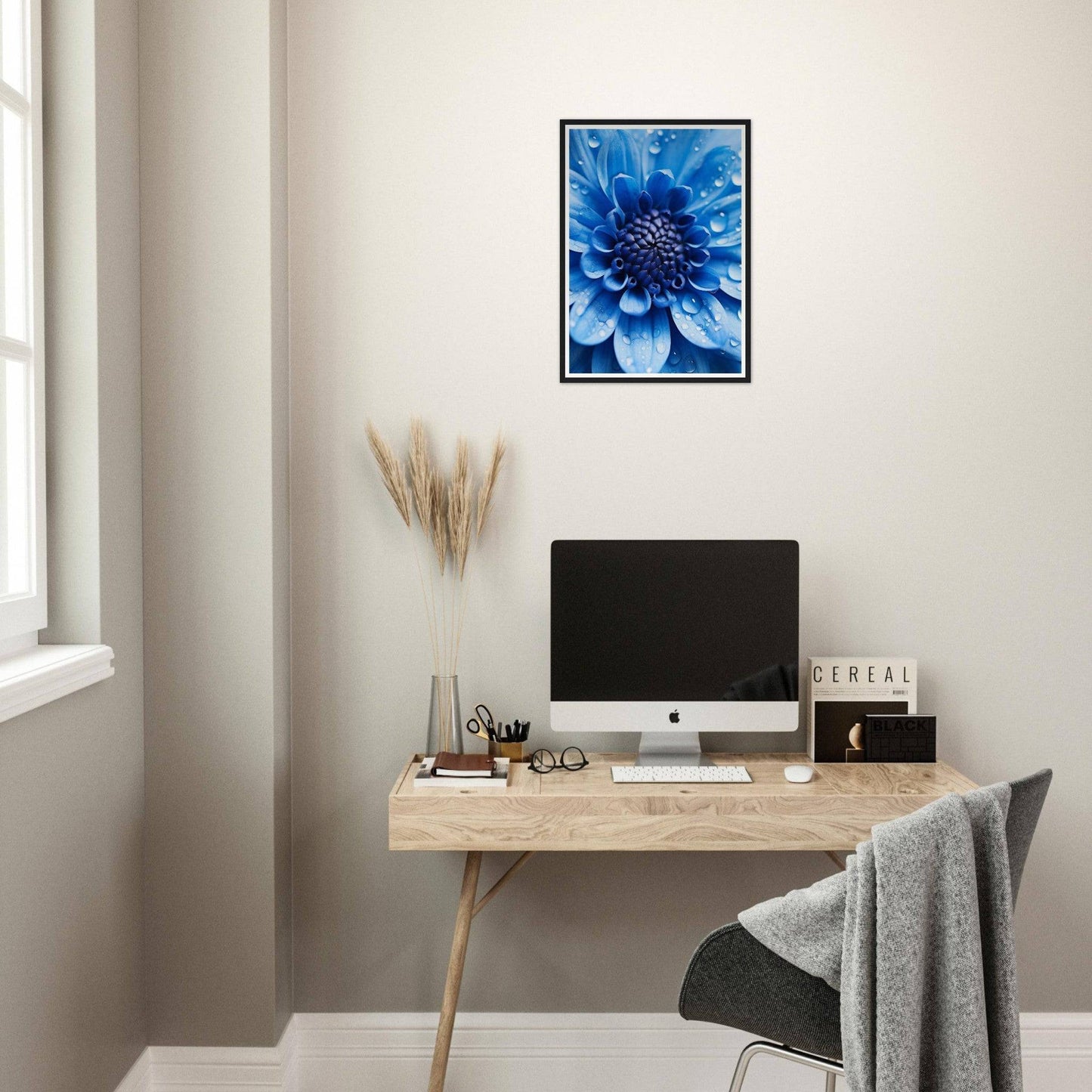 Vibrant blue flower with intricate petals in close-up view, framed on a wall.