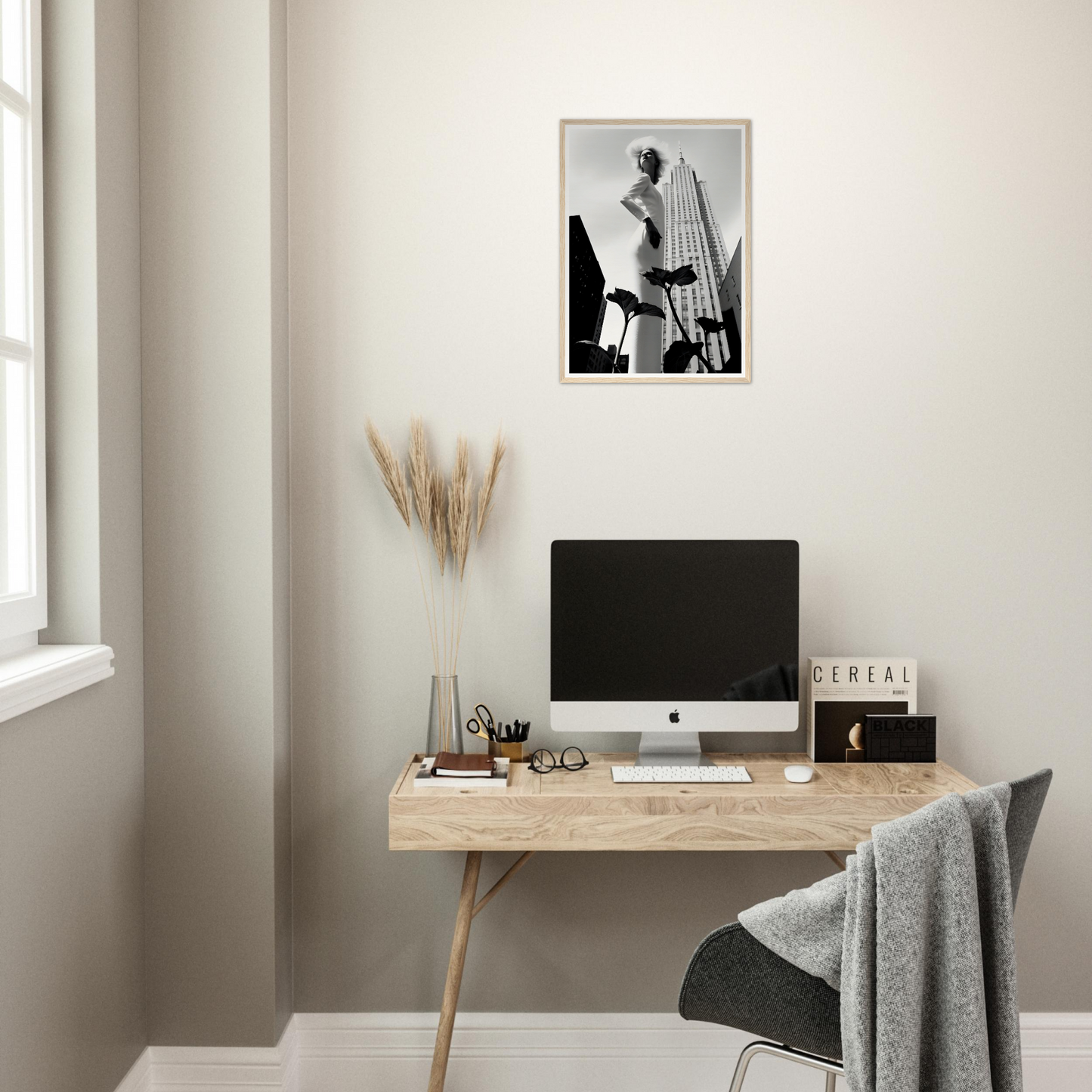 Minimalist wooden desk with a computer monitor and decorative accessories.