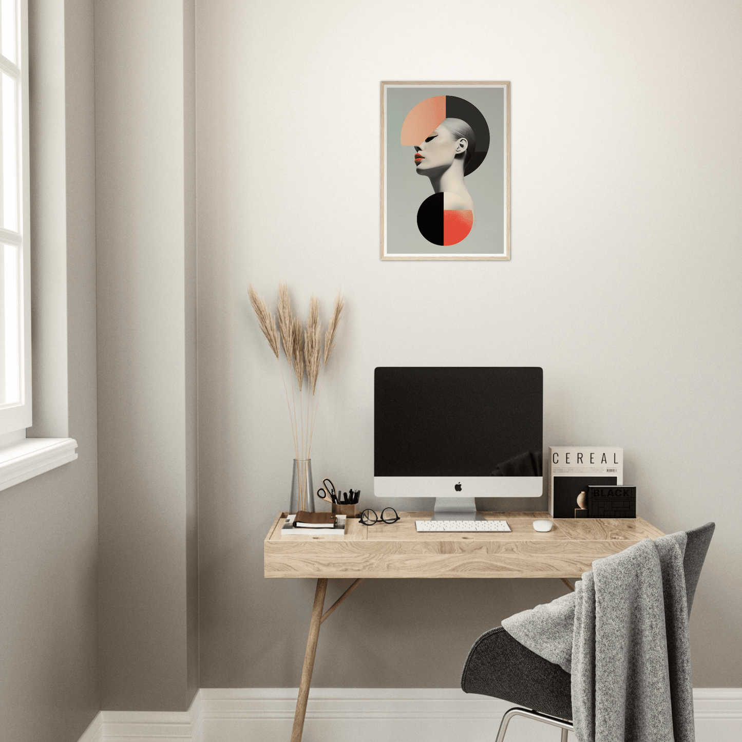 Minimalist home office workspace with a wooden desk, computer, and modern wall art.