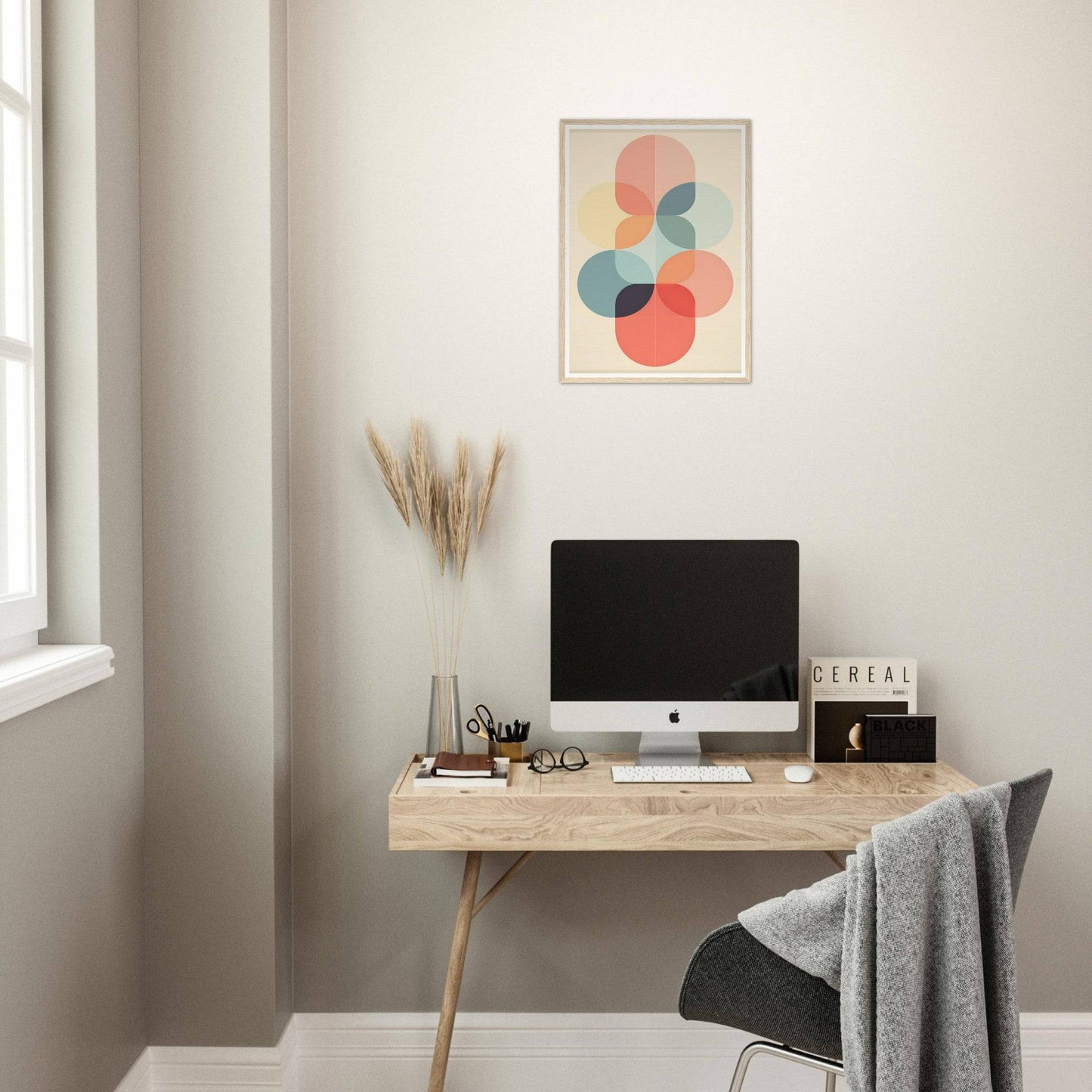 Minimalist wooden desk with a computer monitor and office accessories.