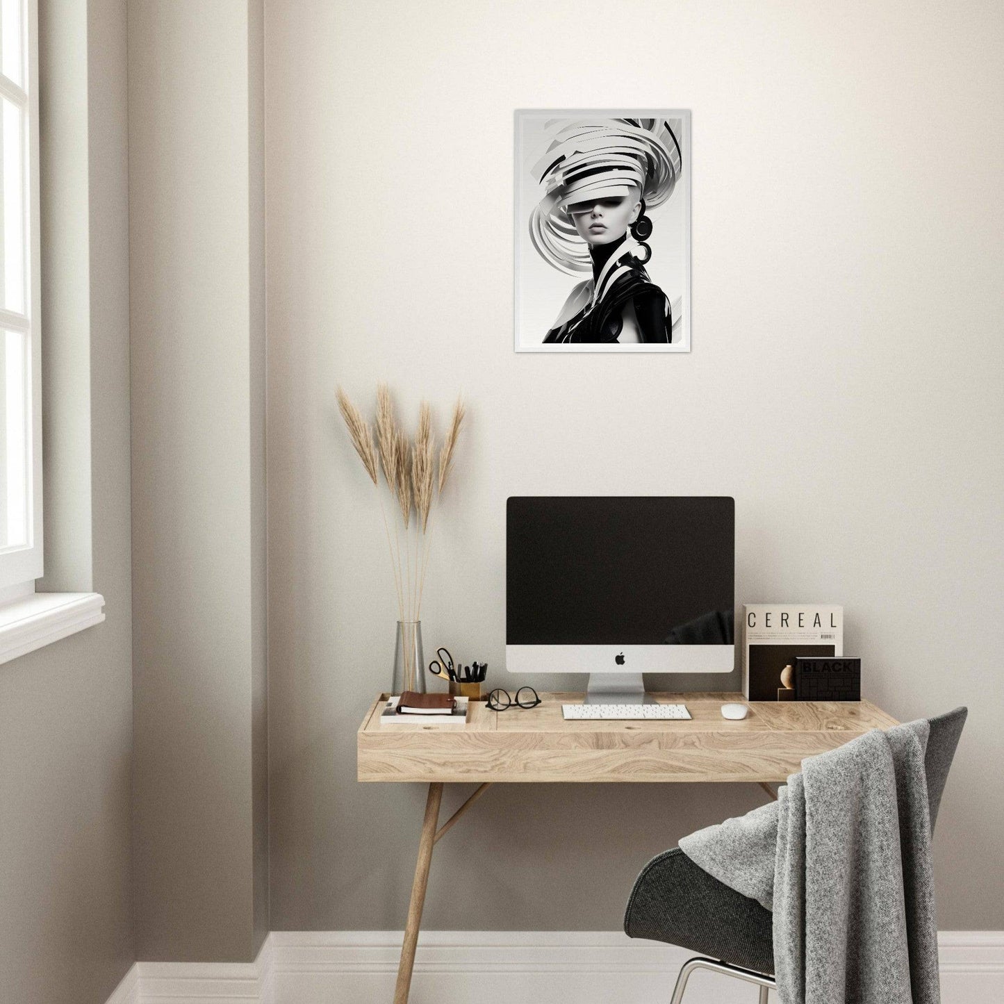 Minimalist home office workspace with a wooden desk, computer, and artistic wall print.