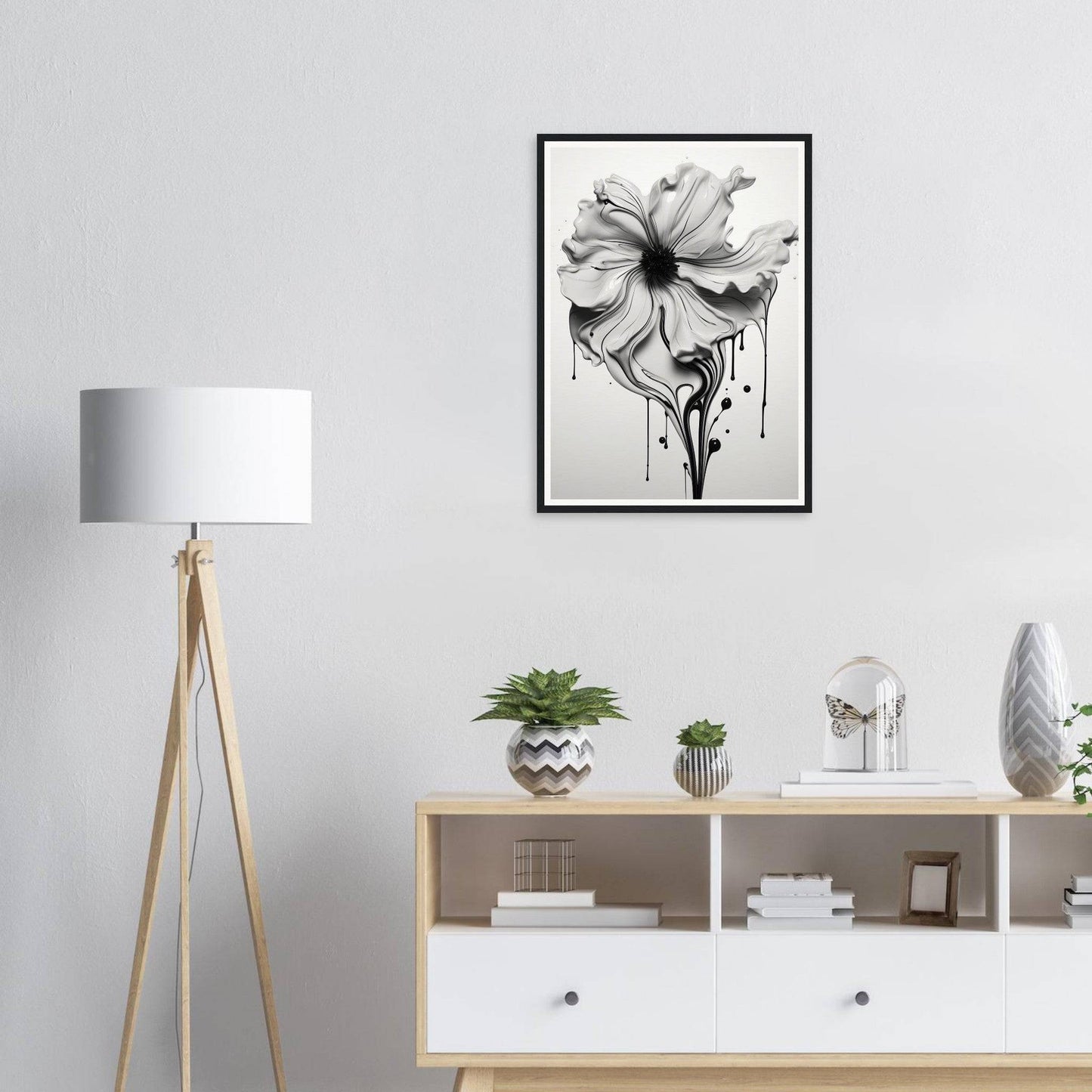 A close up of a white cabinet with a lamp and a picture on the wall