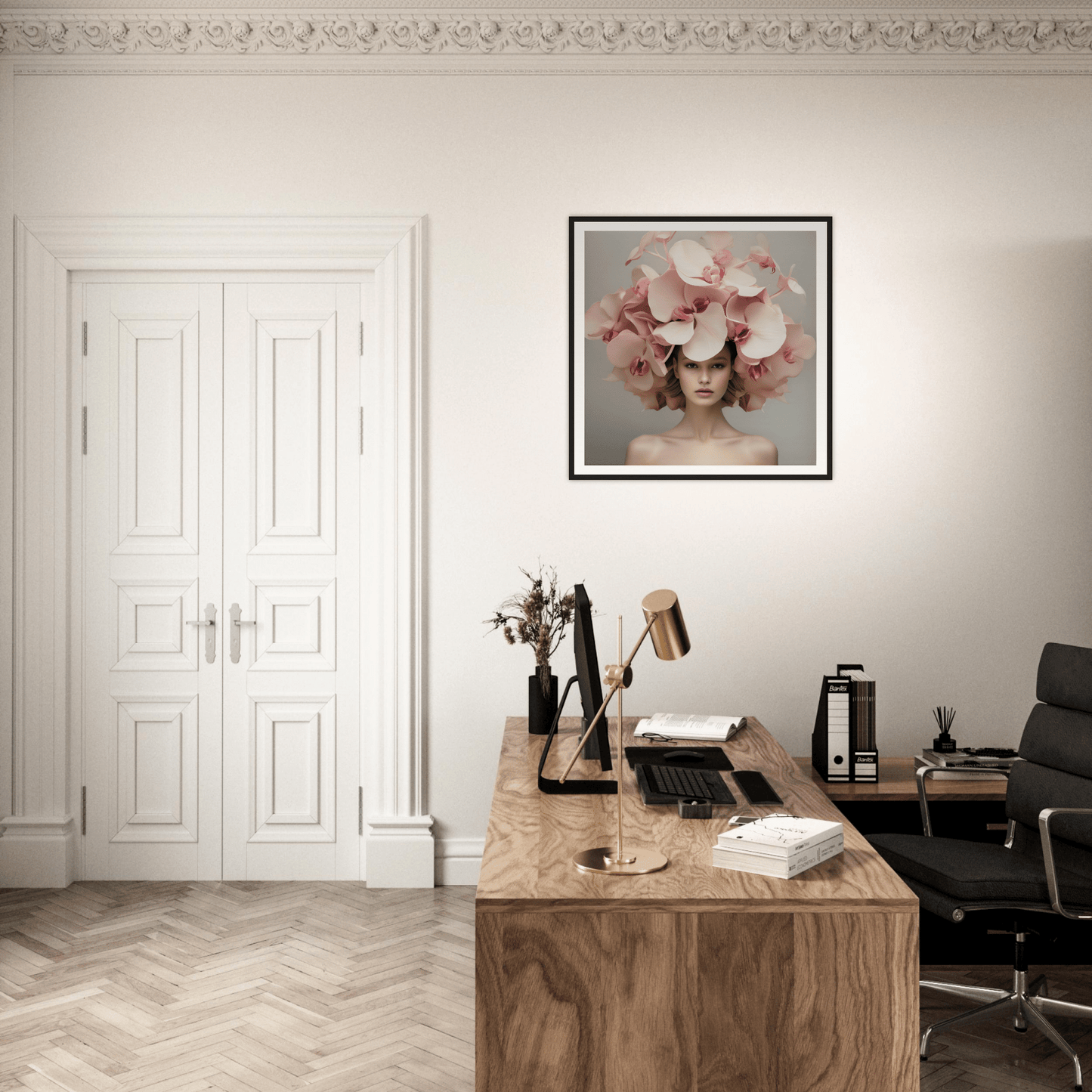 Elegant home office with a wooden desk, framed floral artwork, and white double doors.