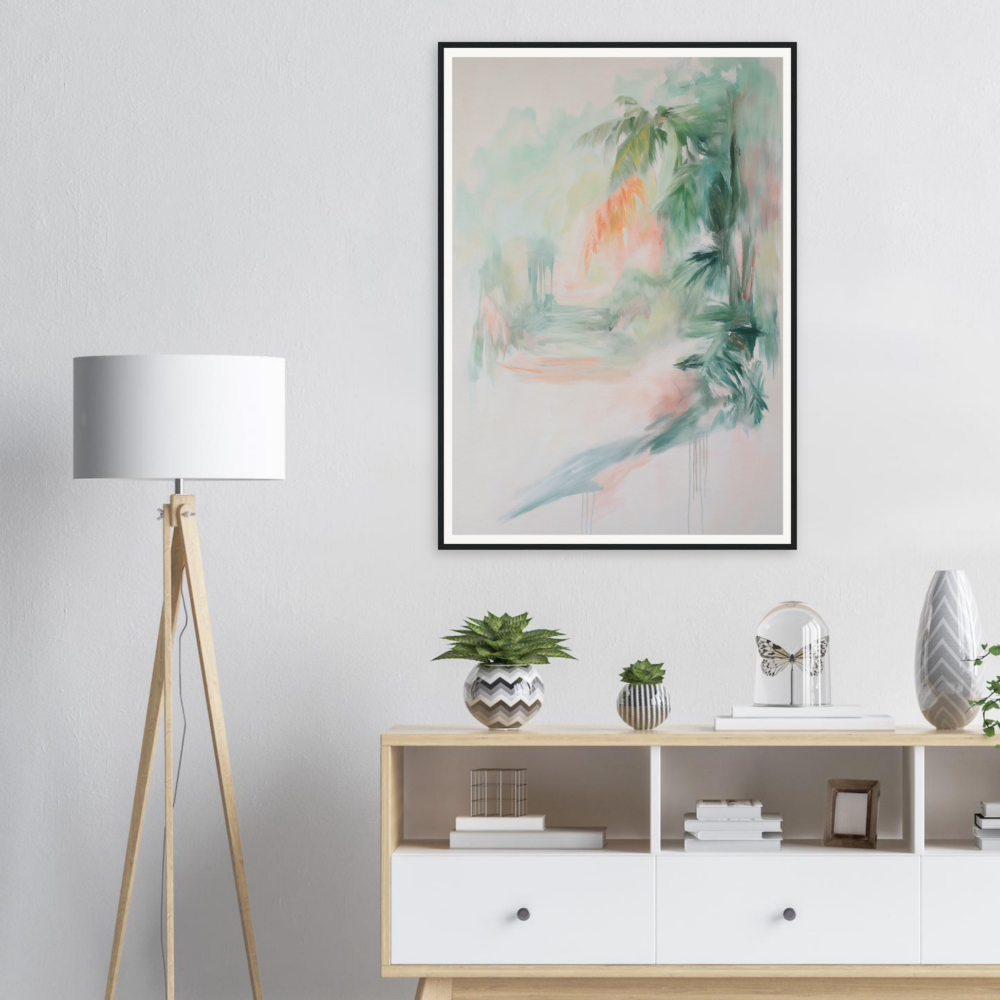 Minimalist living room with framed wall art above a wooden console and a tripod lamp.