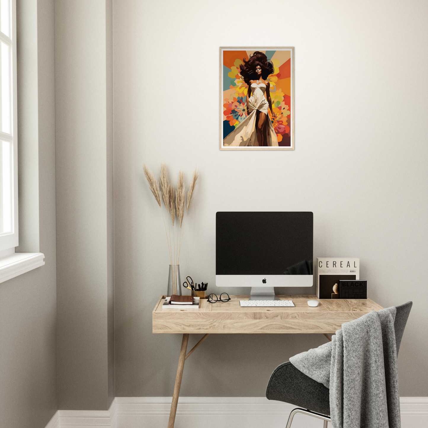 A desk with a computer and a painting on it