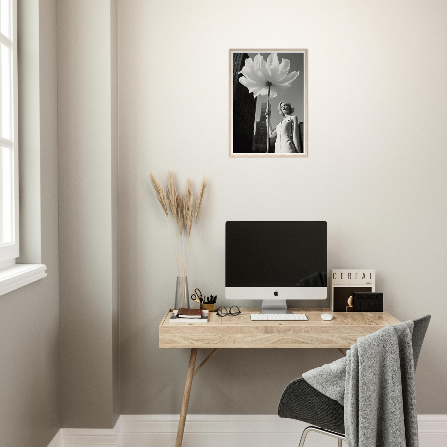 A desk with a computer and a plant on it