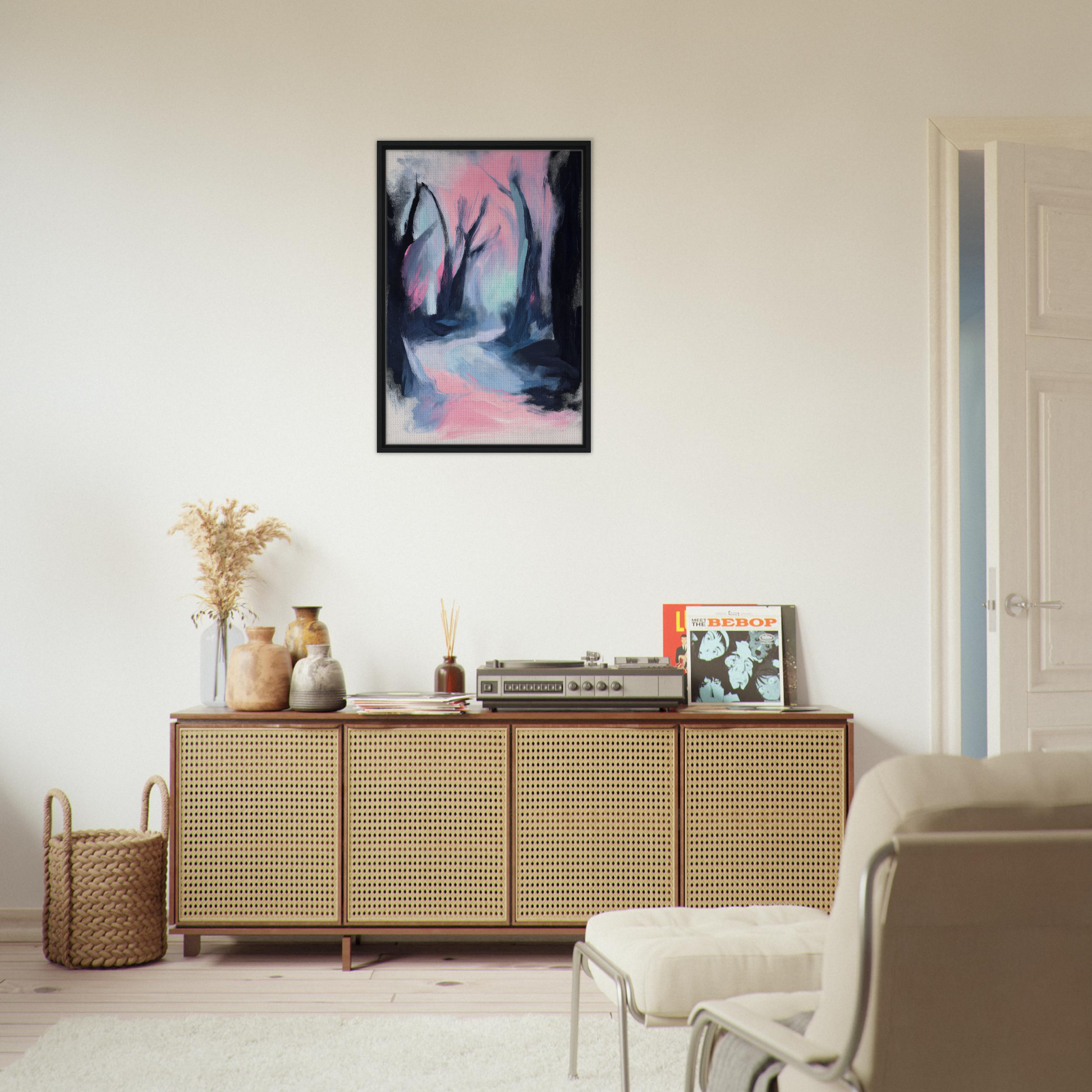 Wooden sideboard with cane-webbed doors showcasing decorative items and Enchantment Framed Canvas