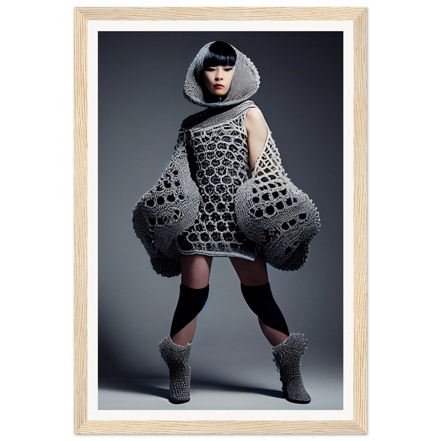 Avant-garde dress with a honeycomb-like pattern and exaggerated silhouette worn by a model.