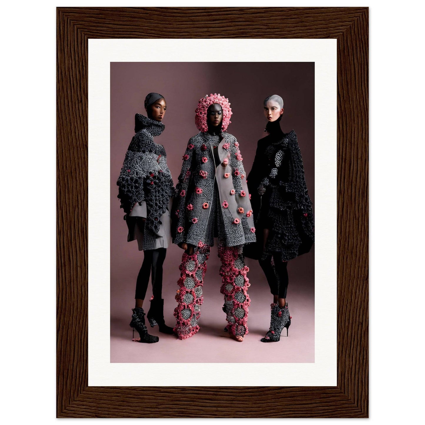 Framed photograph of three figures wearing elaborate, textured coats and headwear in muted and floral designs.