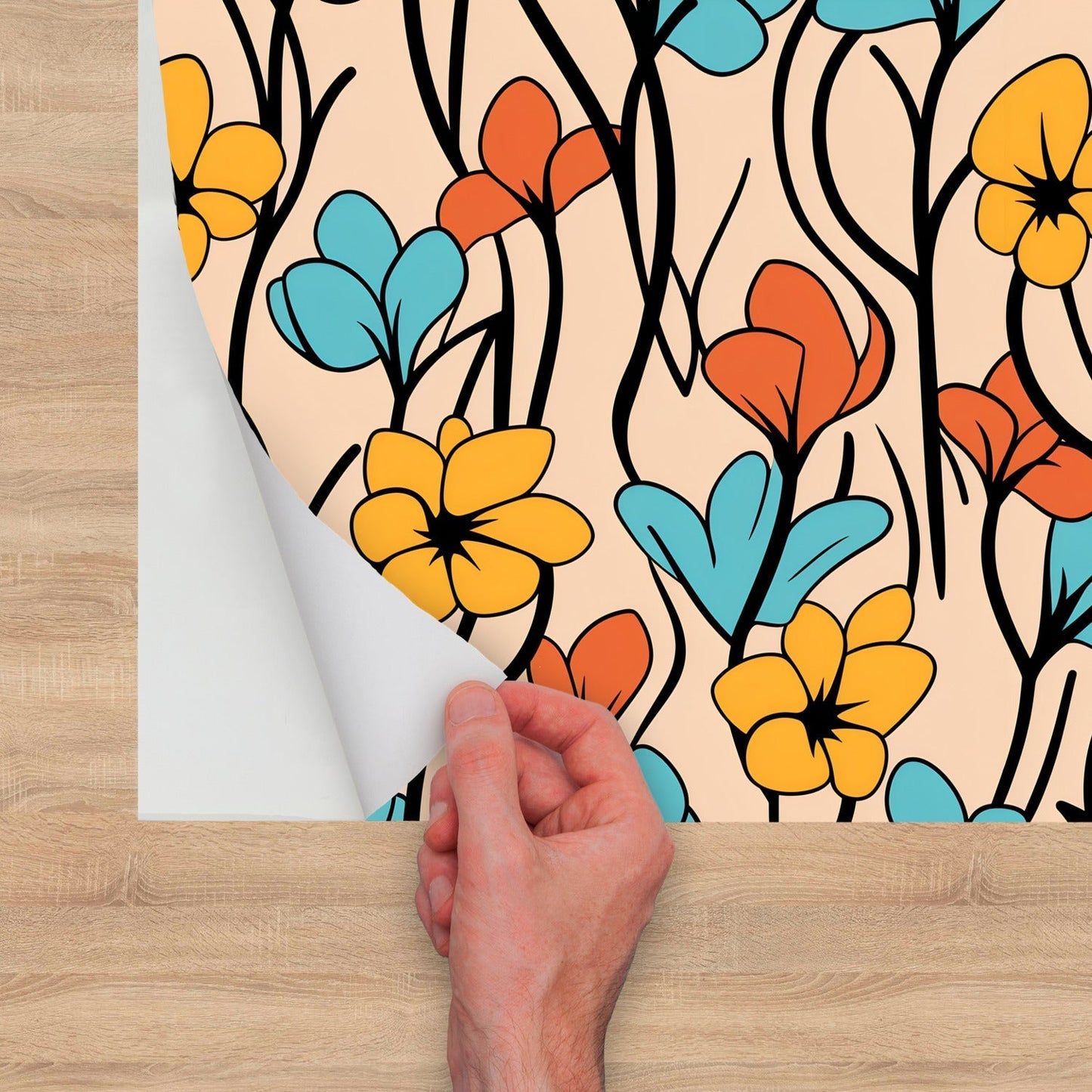 Colorful floral patterned wallpaper being applied or peeled back by a hand.