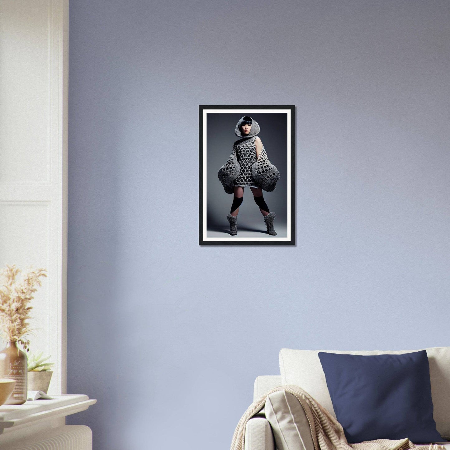 Framed photograph of a person in an avant-garde outfit striking a dramatic pose.