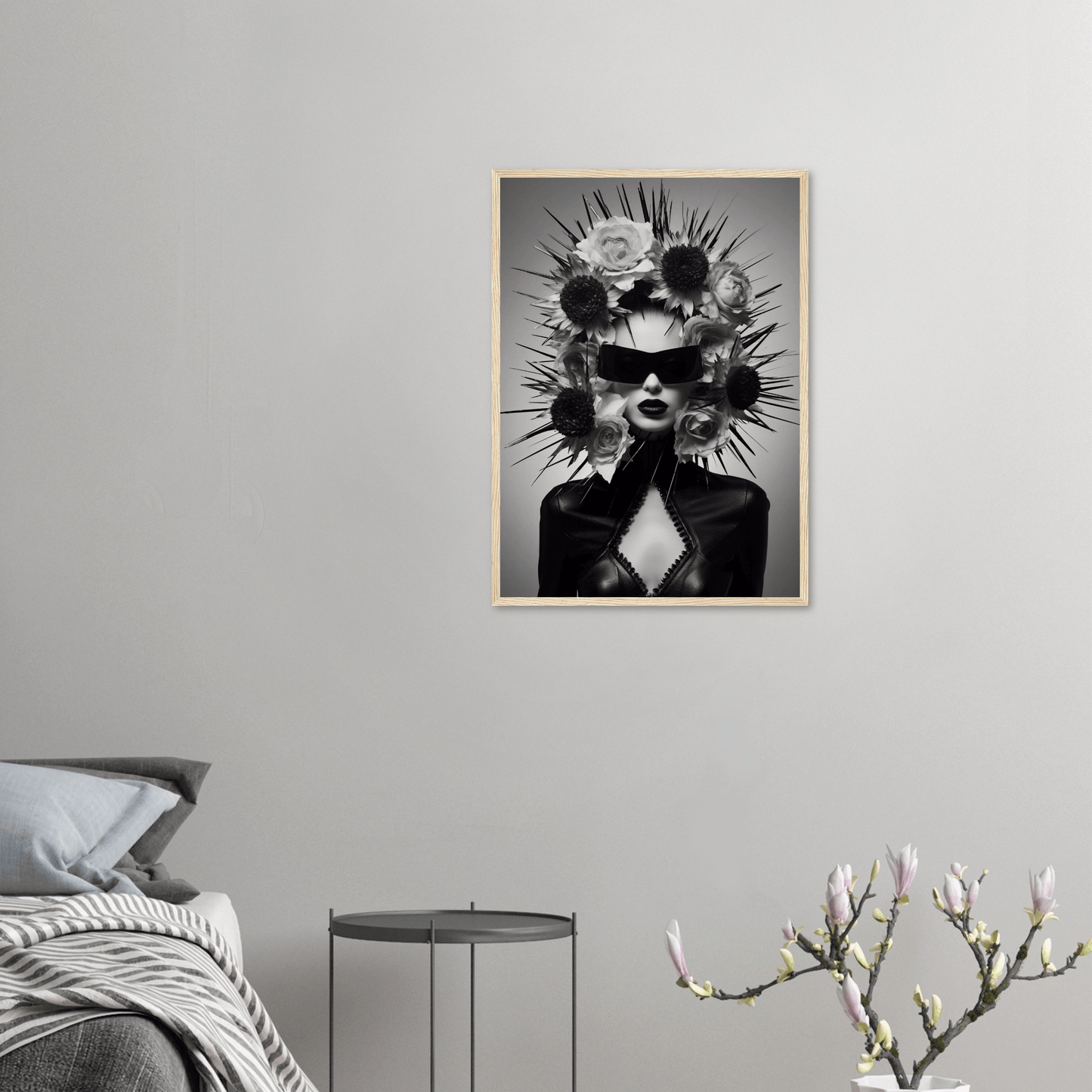 Striking black and white portrait of a figure wearing an elaborate spiked headdress and sunglasses.