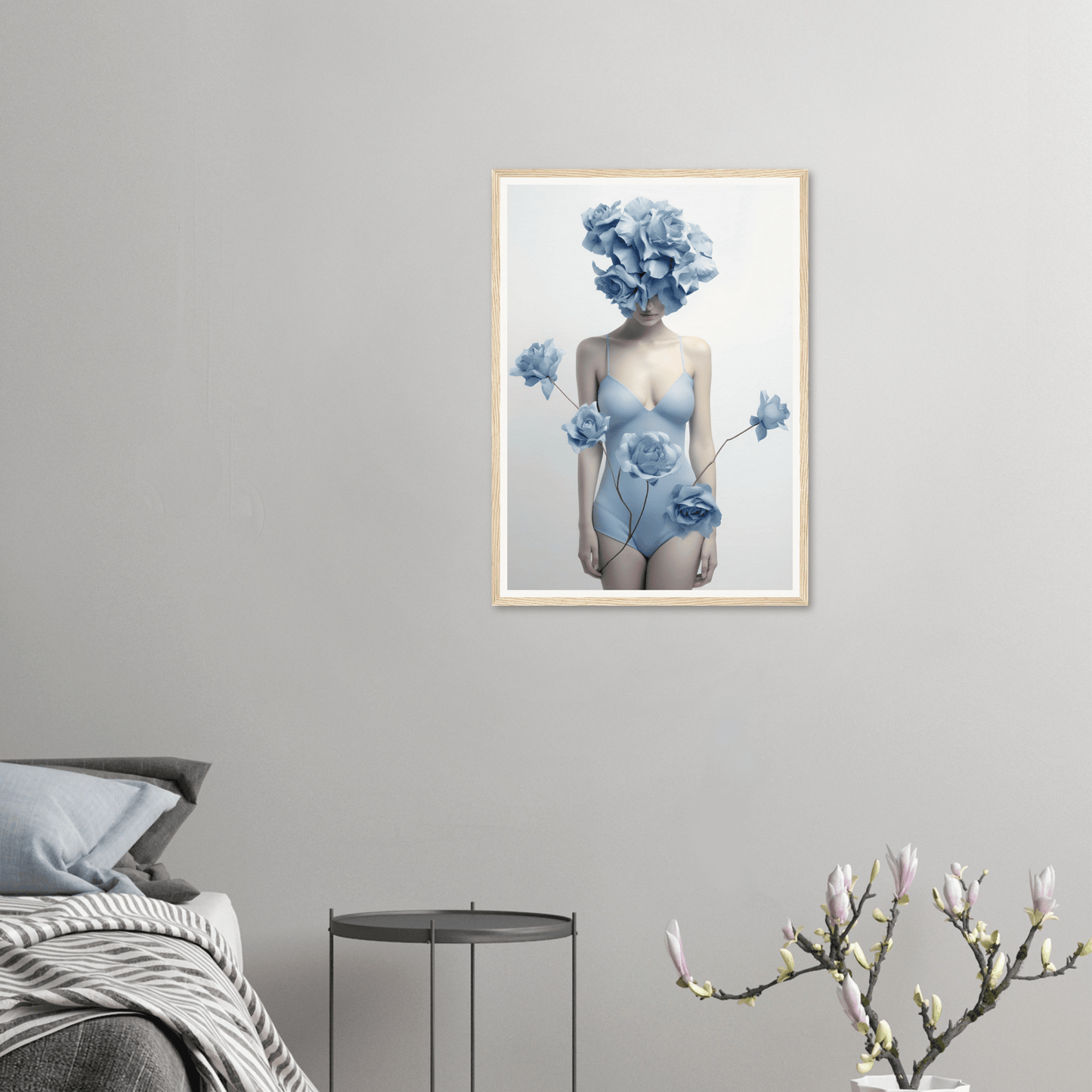 Framed artwork depicting a surreal female figure with blue floral elements replacing the head and hands, wearing a pale bodysuit.