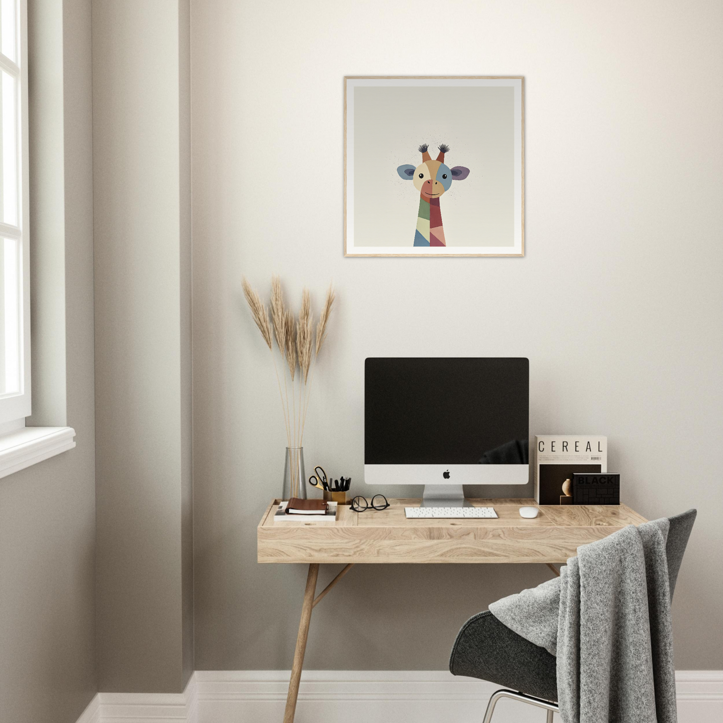 Minimalist wooden desk featuring iMac and Chroma Tall Tales giraffe artwork above