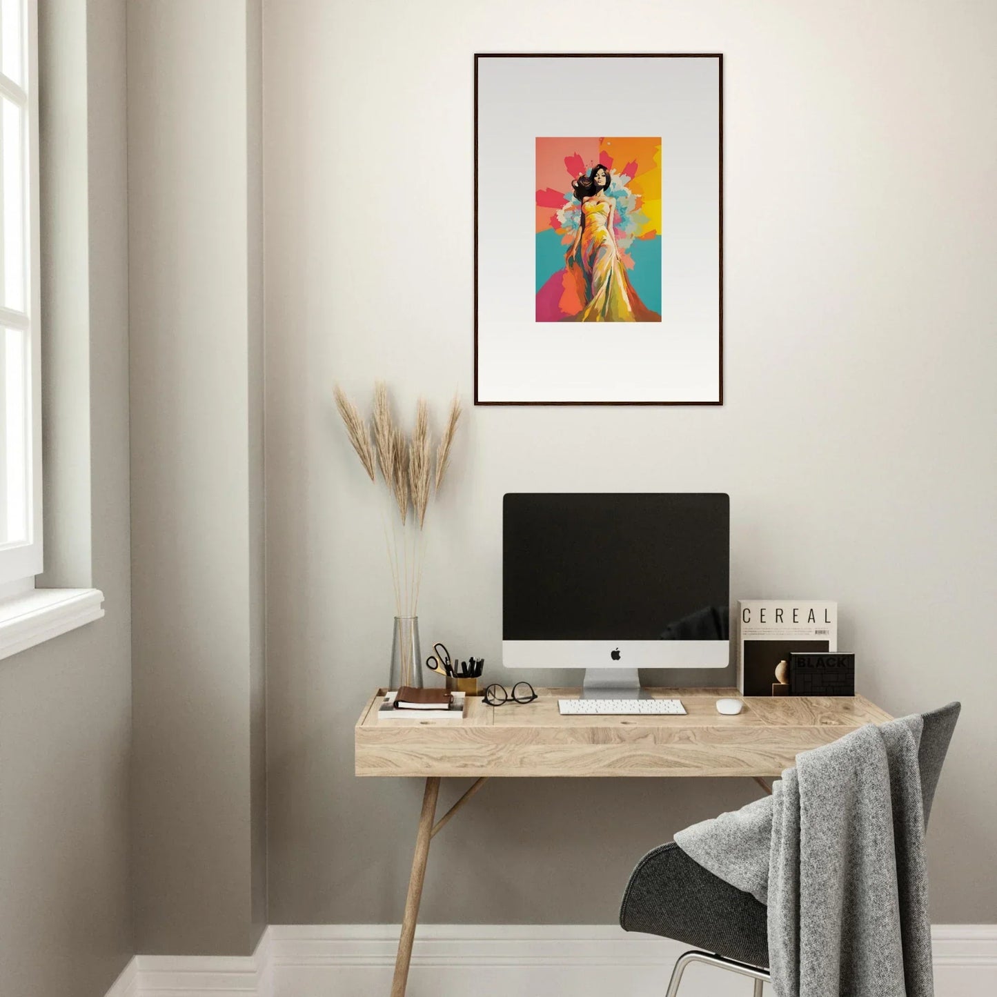 Simple wooden desk with iMac and colorful framed wall art from Chromatic Evolutionary Reverie