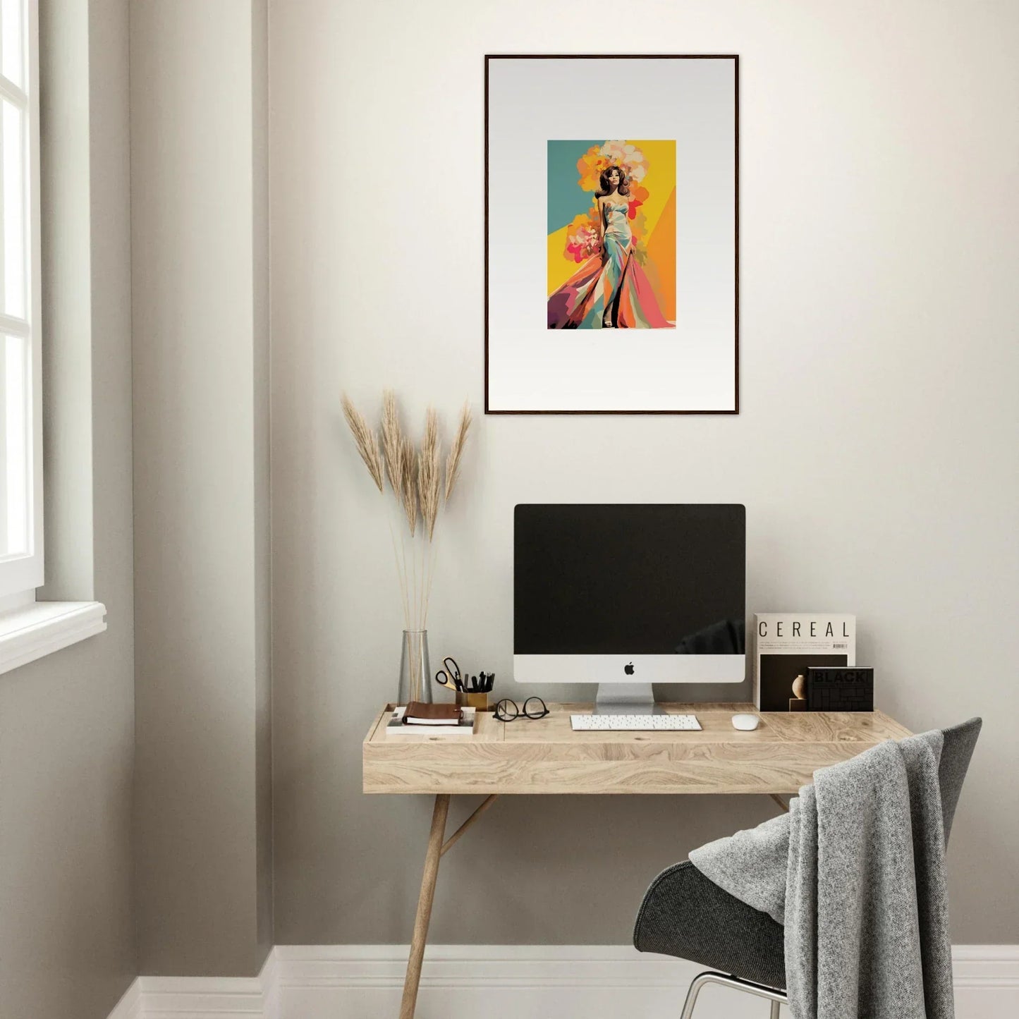 Simple wooden desk with iMac and Chromatic Sunset Muse framed wall art above it
