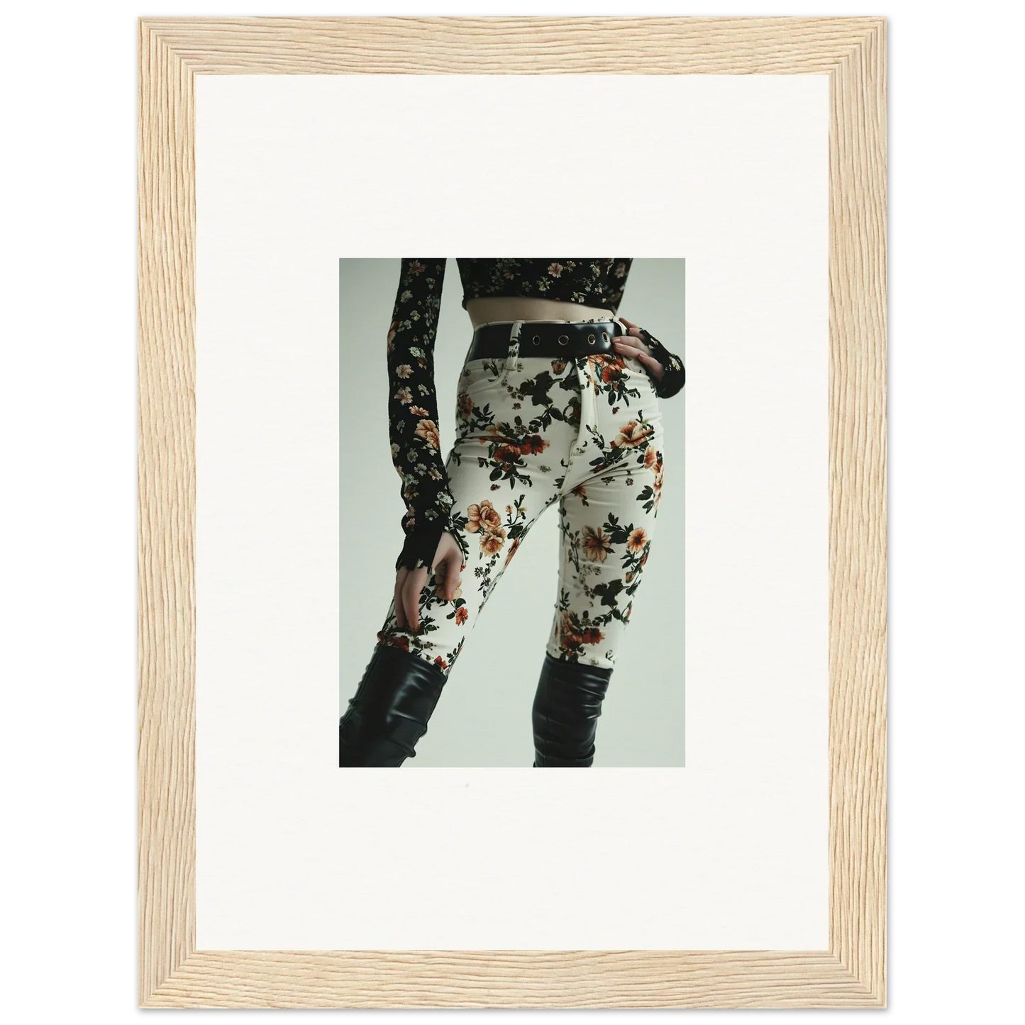Framed photograph of floral-patterned pants or leggings with lace details.