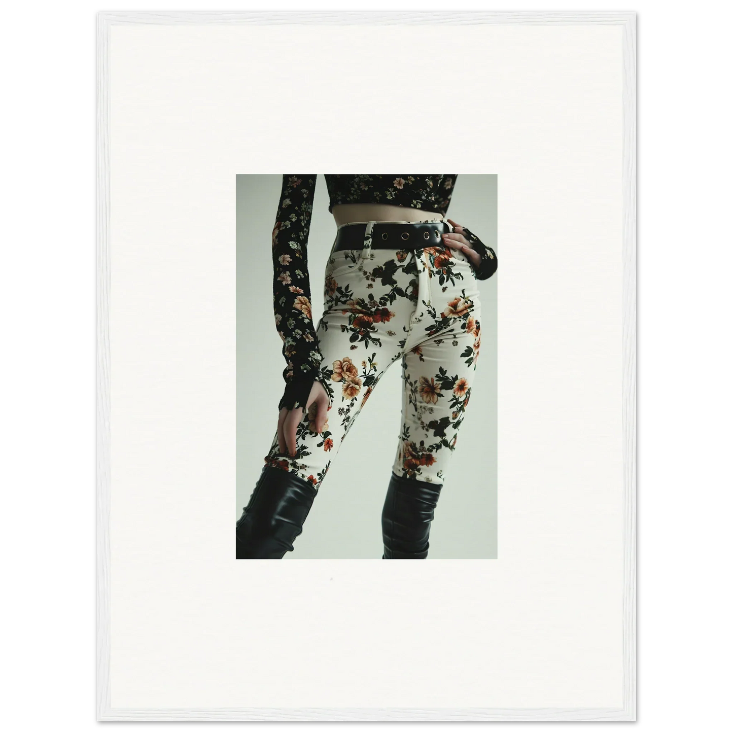Floral print pants with a black belt worn by a person.
