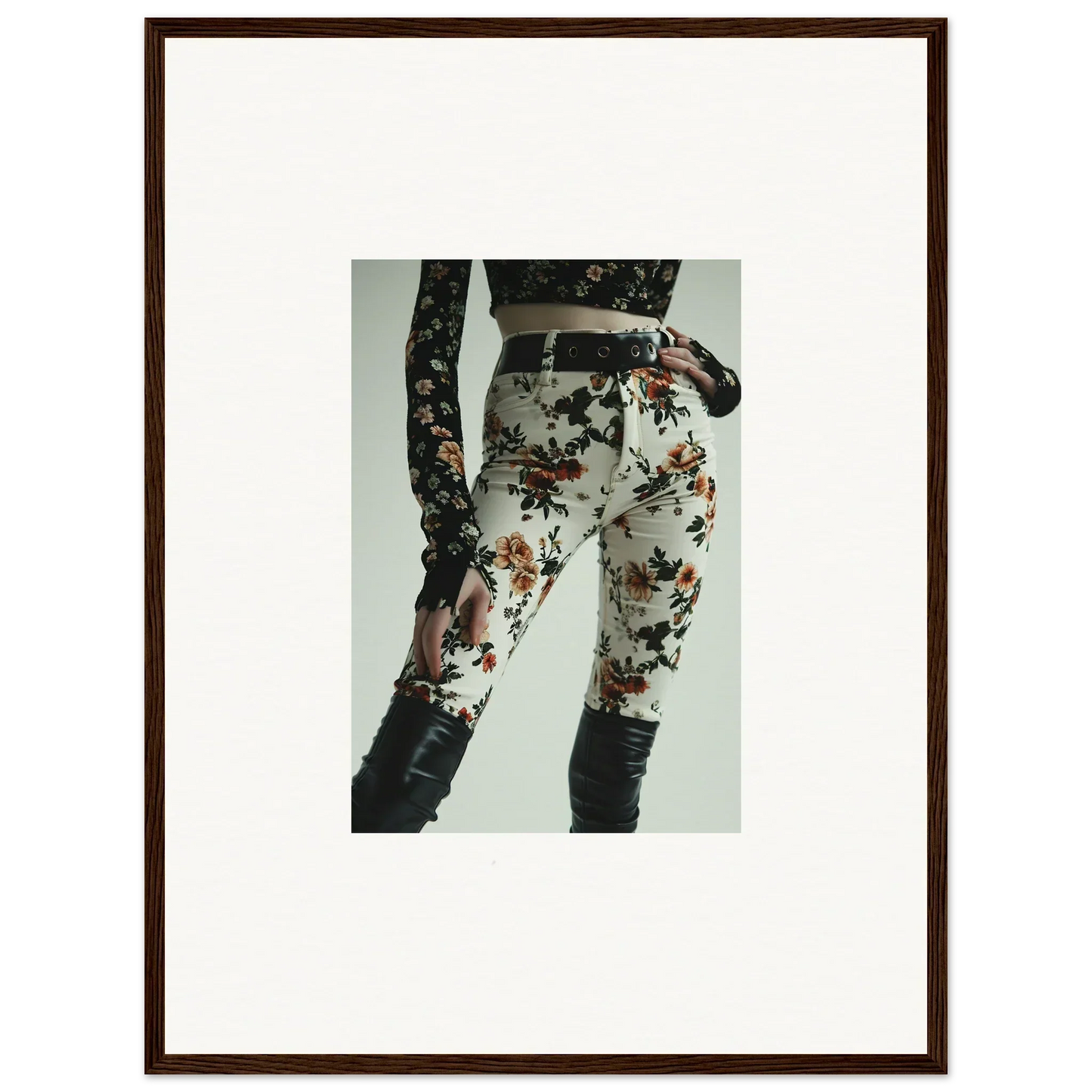 Framed photograph of a person wearing floral-patterned pants and a dark top.