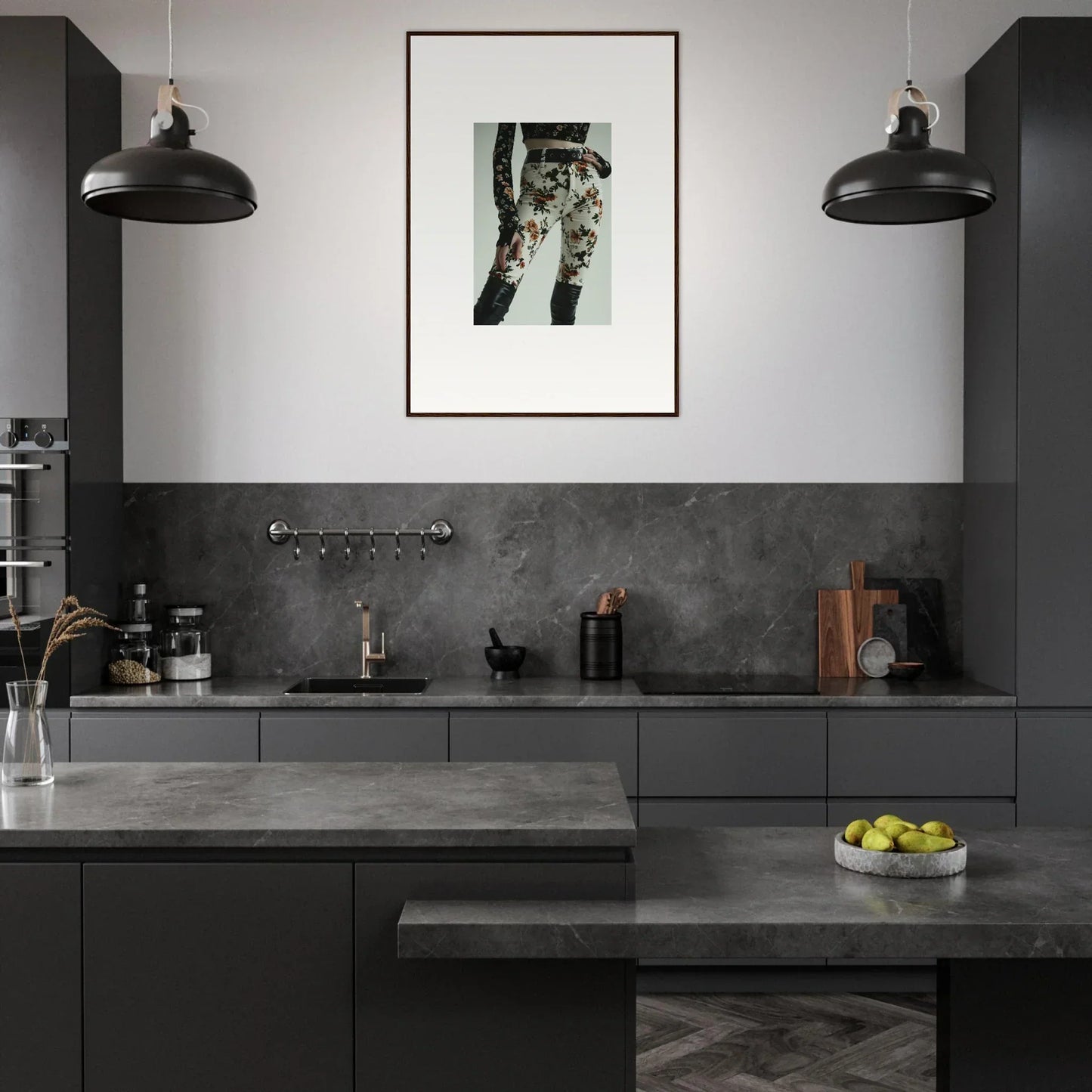 Modern kitchen with dark gray cabinetry and countertops, featuring pendant lights and a framed artwork.