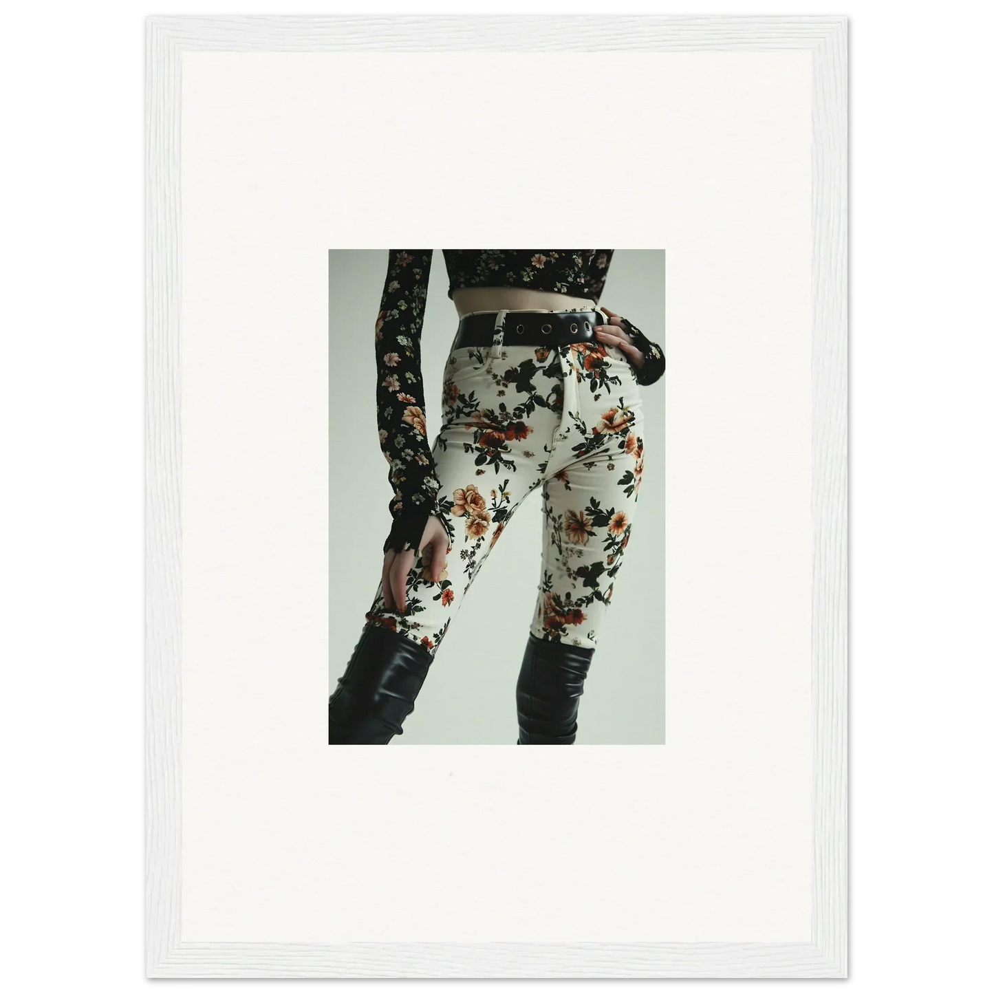 Floral-patterned pants with a black belt and lace-up detail on the side.