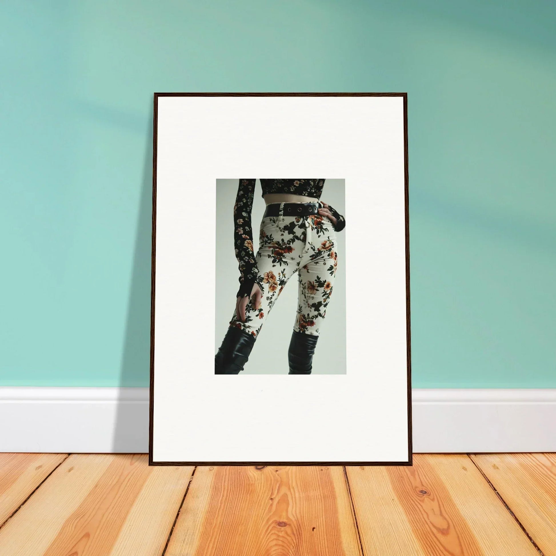 Framed black and white photograph of legs wearing floral patterned pants.