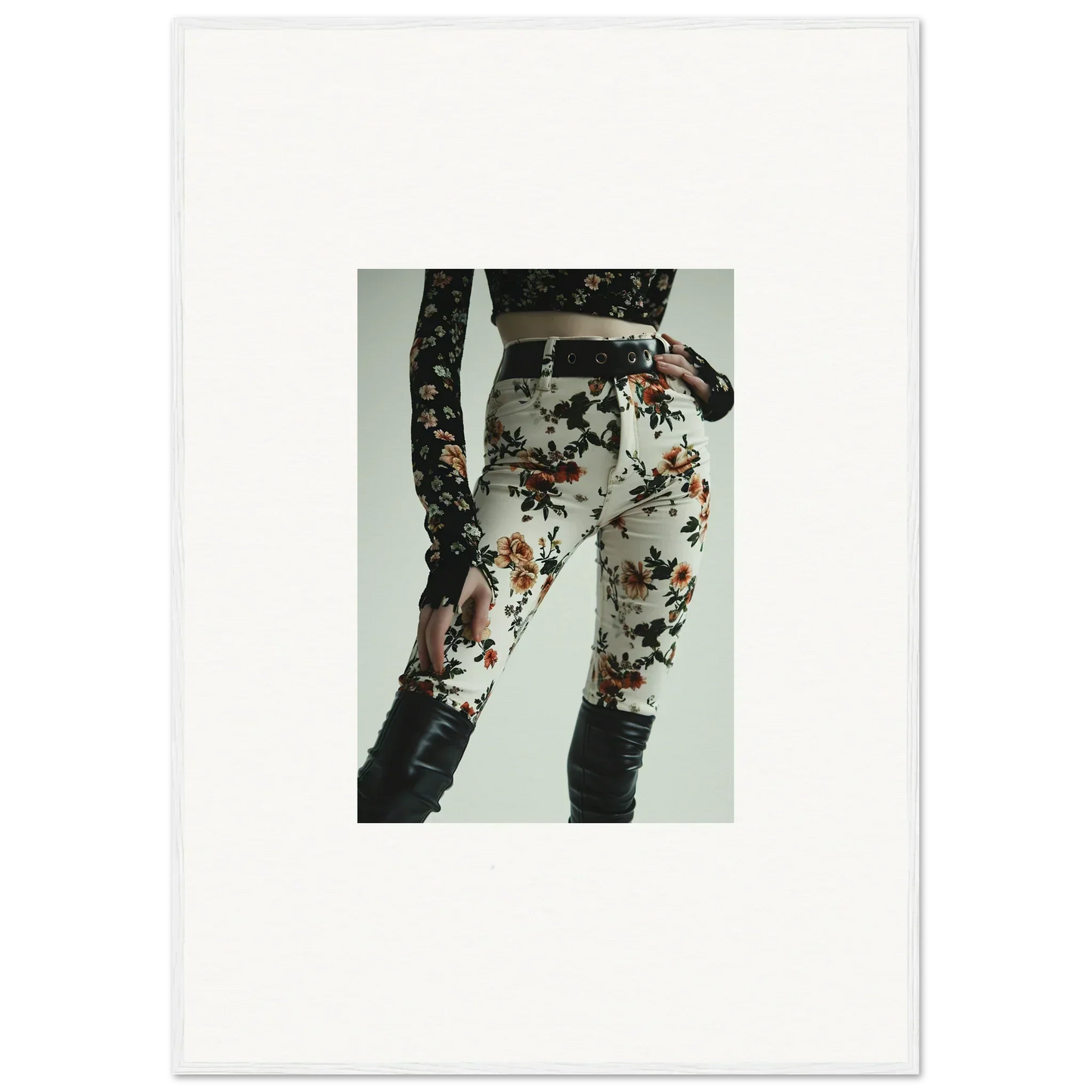 Floral-patterned white pants or leggings with a black belt.