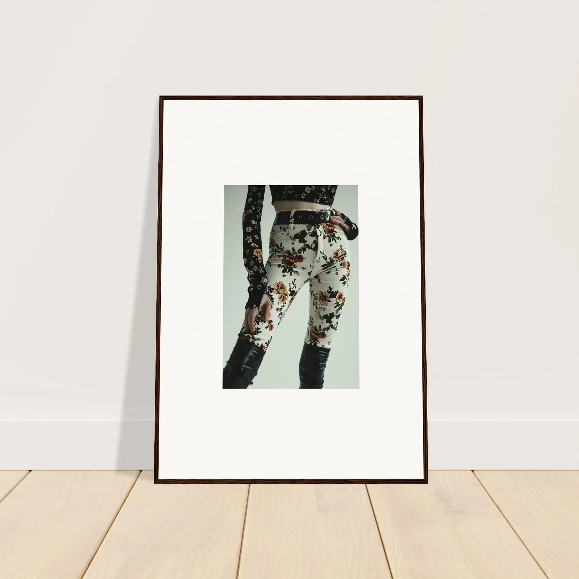 Framed artwork depicting legs wearing floral-patterned pants.
