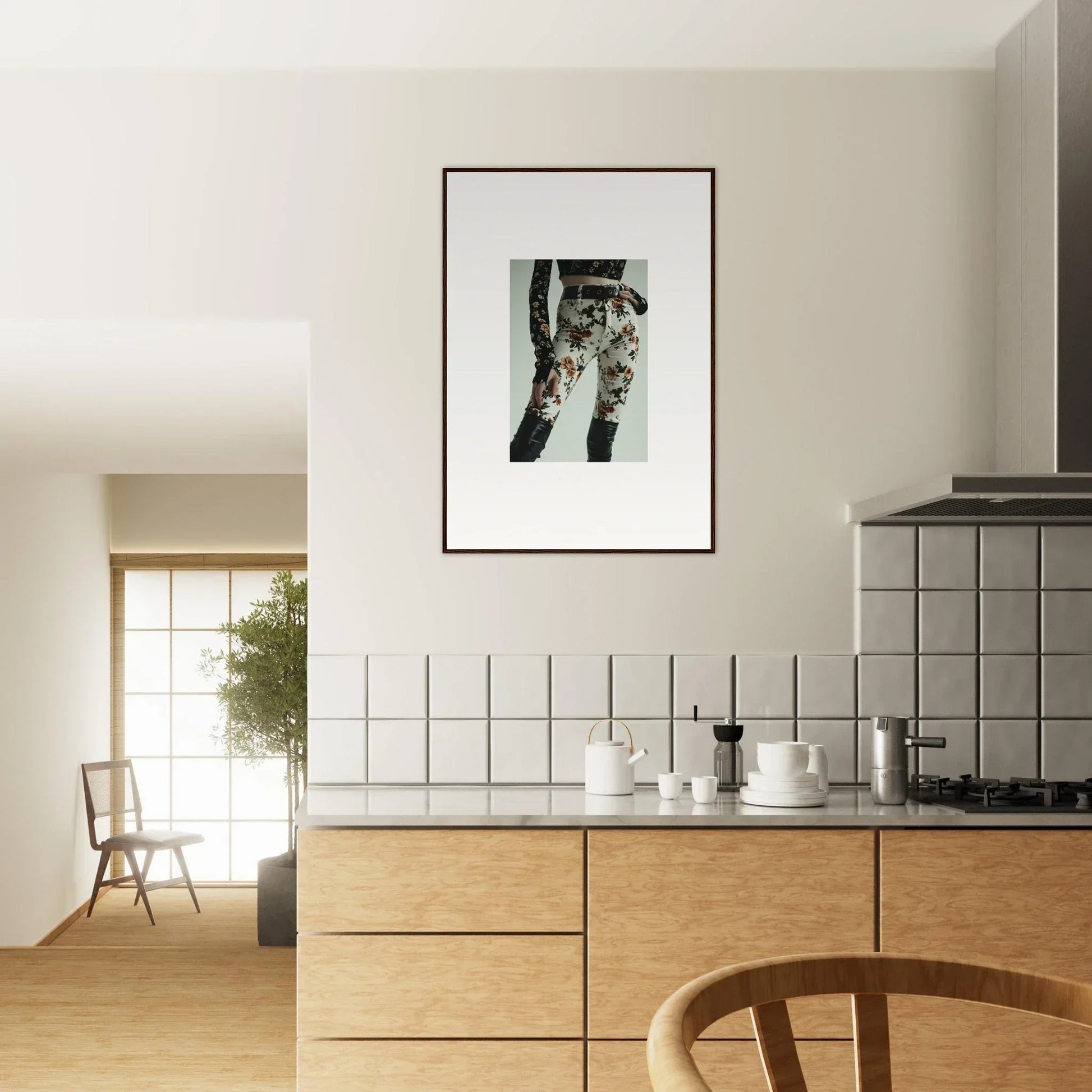 Modern kitchen with wooden cabinets, white tiled backsplash, and framed artwork on the wall.