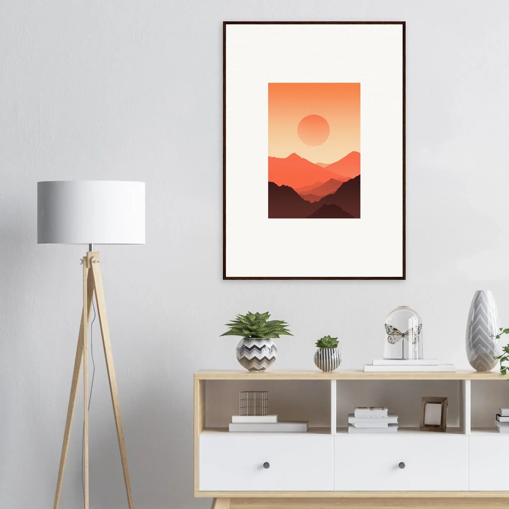 Framed wall art of a sunset over mountains in warm orange tones for room decor