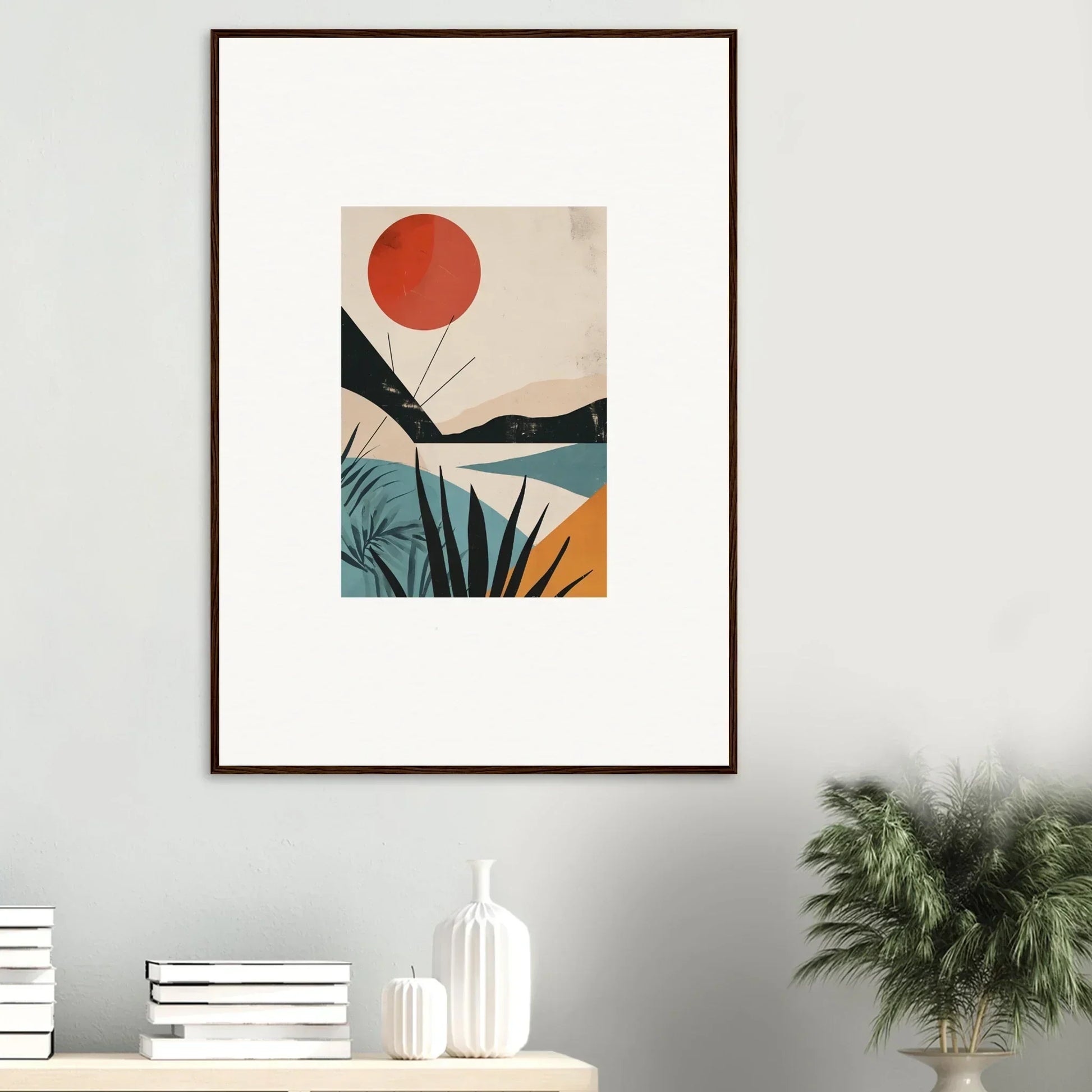 Framed wall art featuring a red sun over abstract landscape and tropical plants