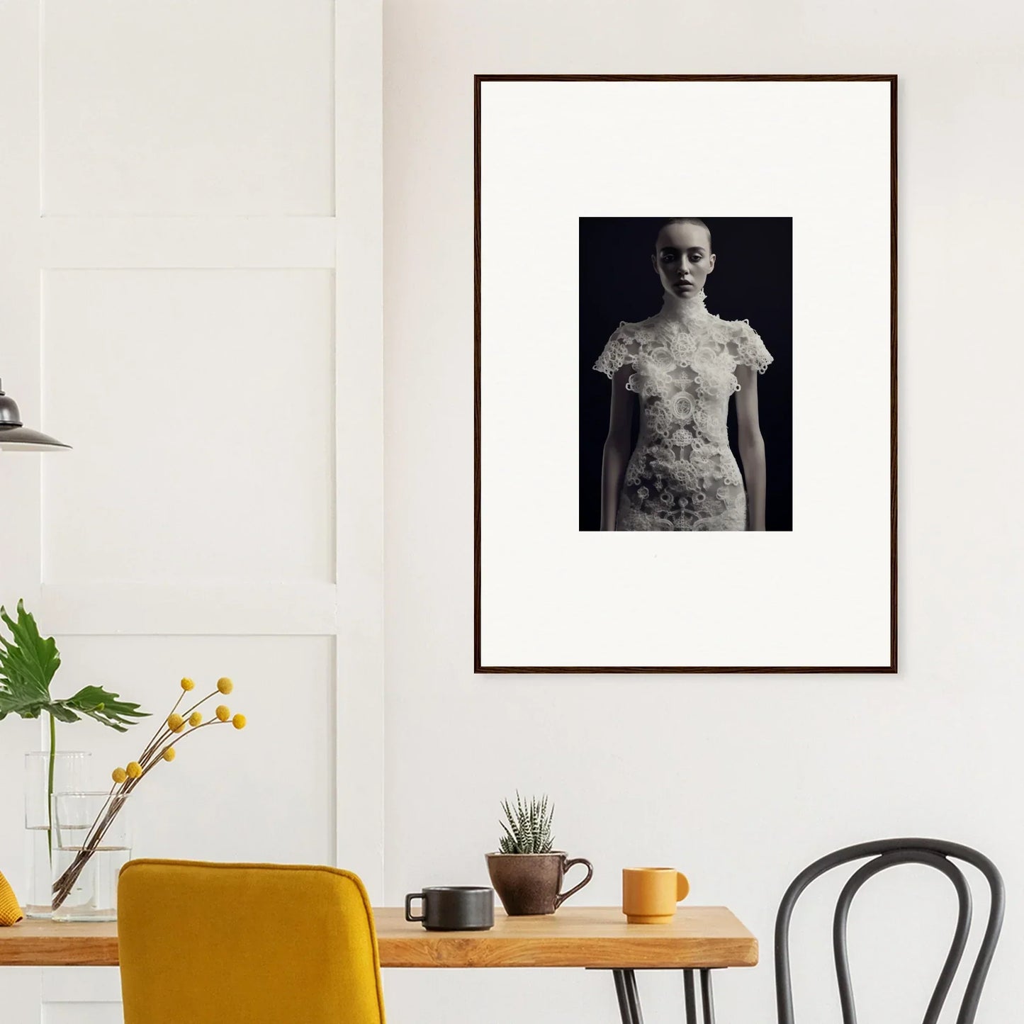 Framed black and white photograph of a person with floral patterns on their skin and clothing.