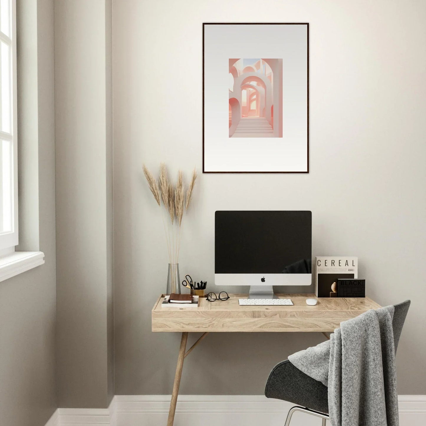 Minimalist wooden desk with a computer monitor and office accessories.