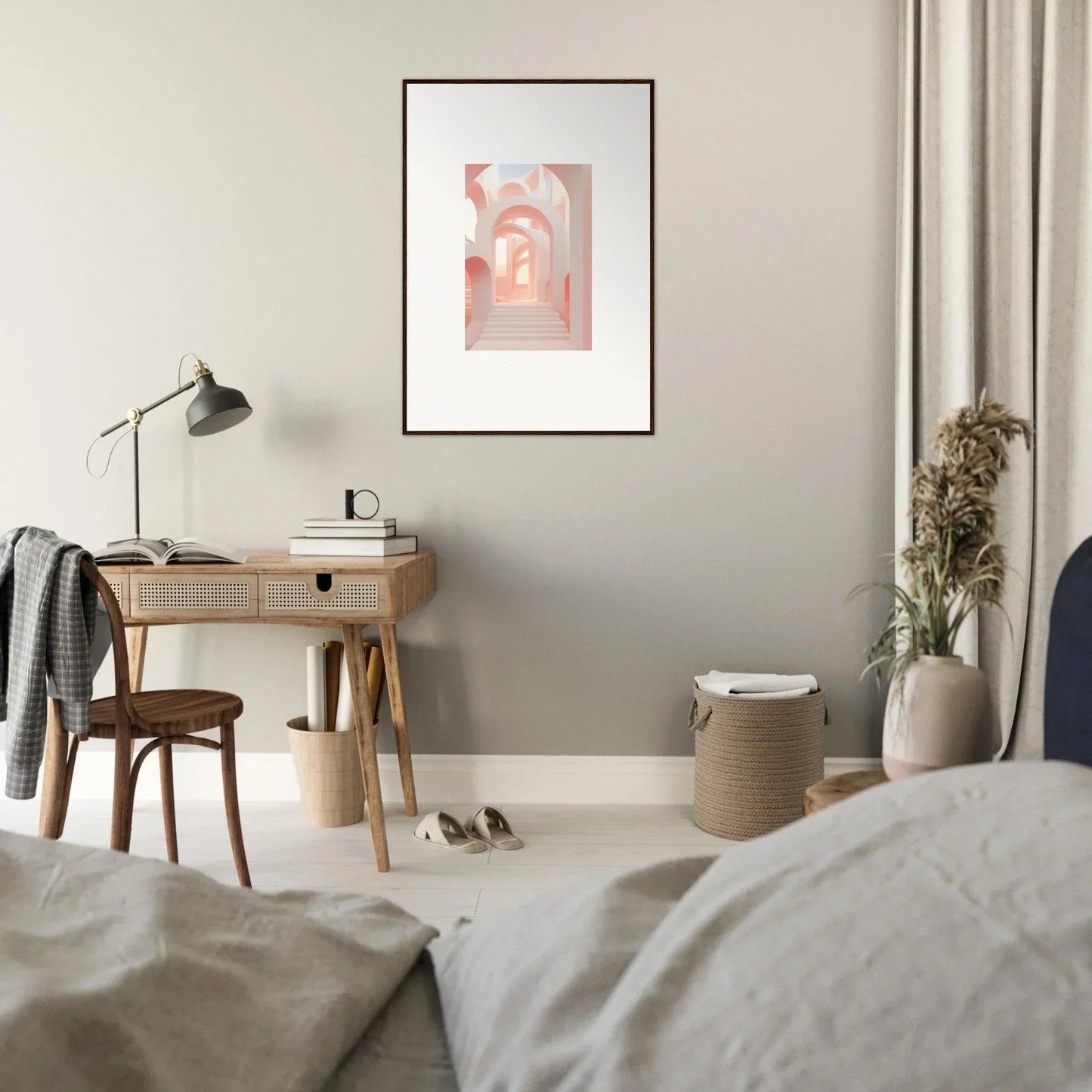Cozy bedroom with a minimalist desk area and framed artwork.