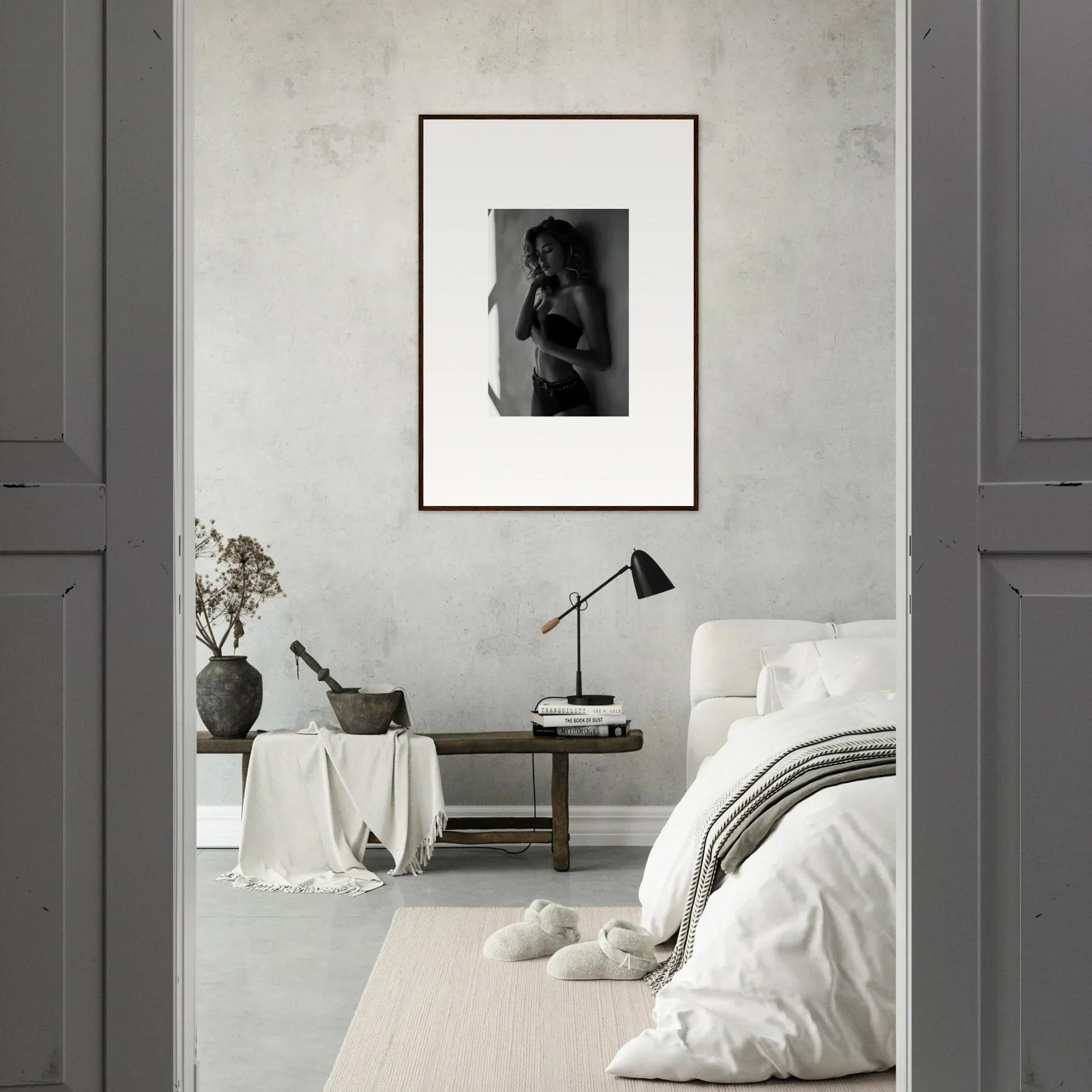 Framed black and white photograph of a figure hanging on a wall.