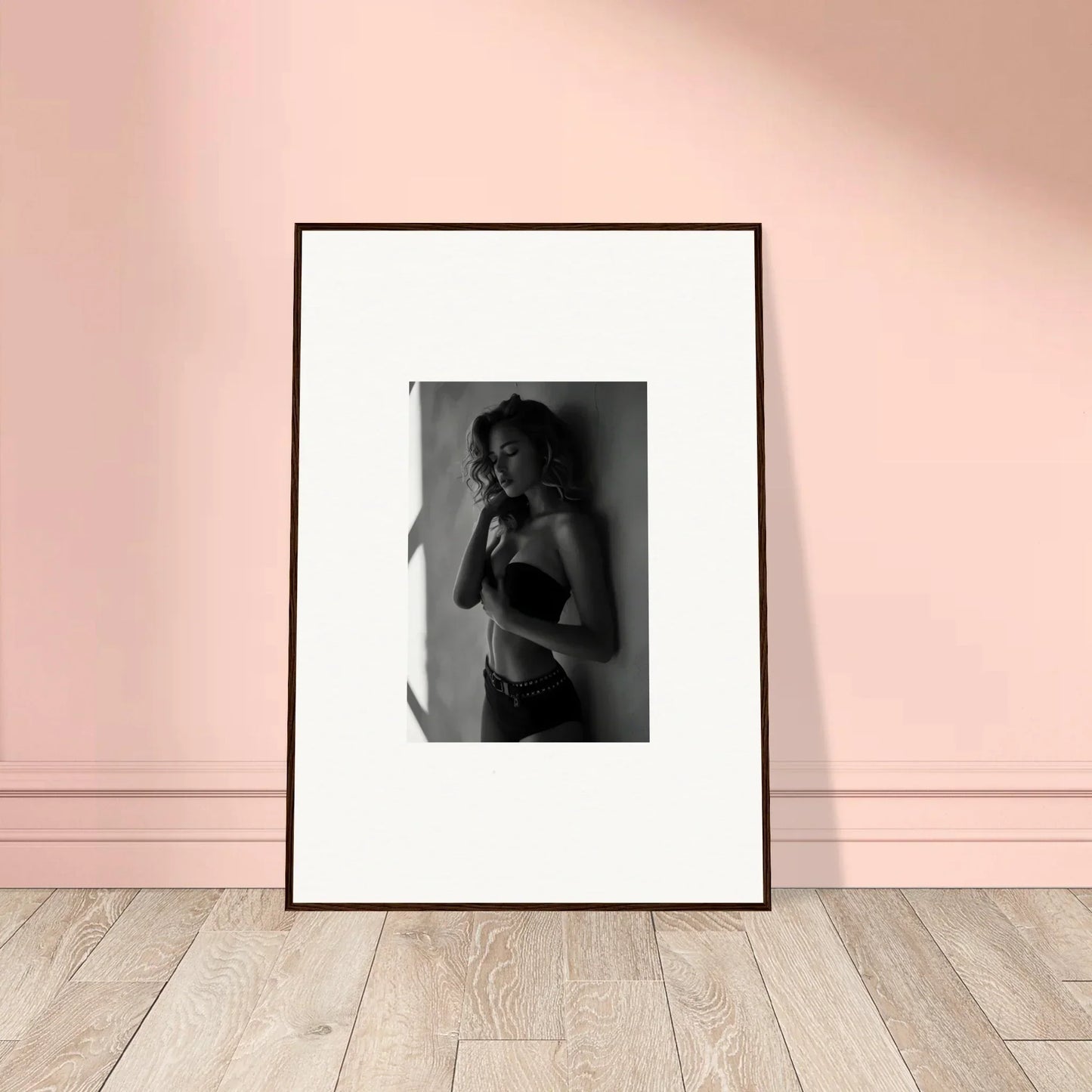 Framed black and white photograph of a person in lingerie.