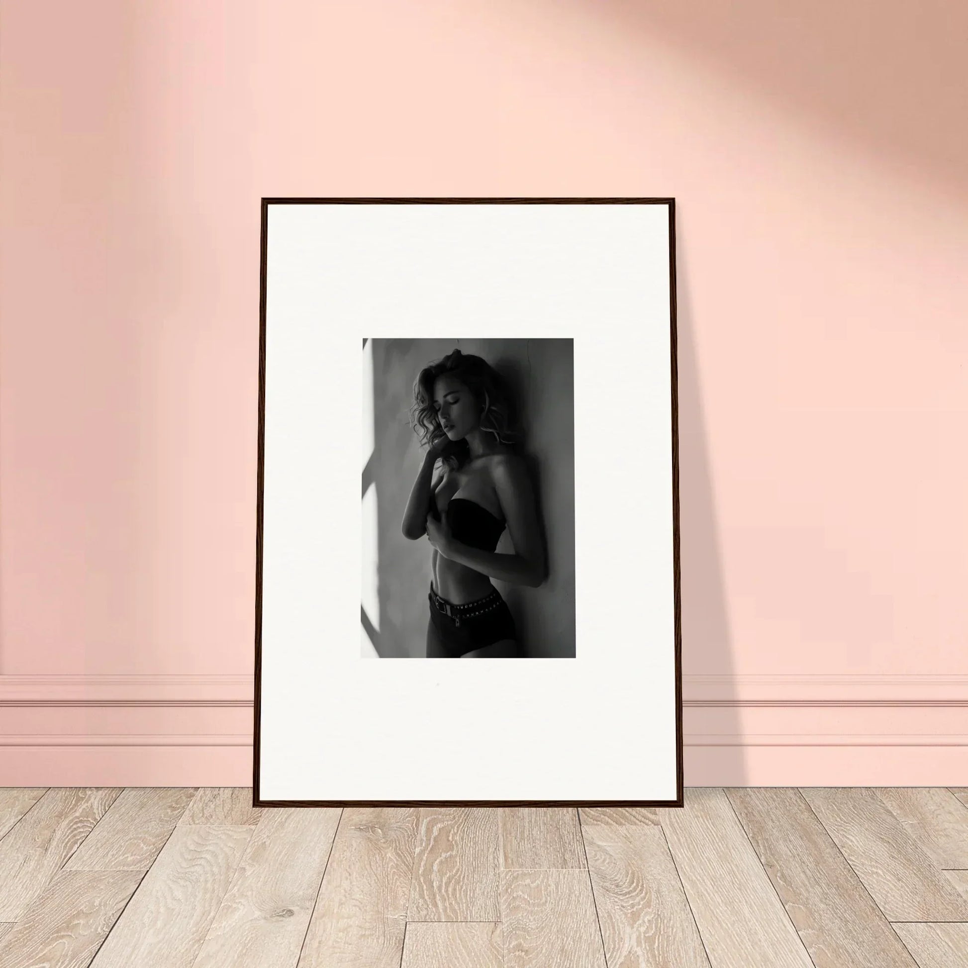 Framed black and white photograph of a person in lingerie.